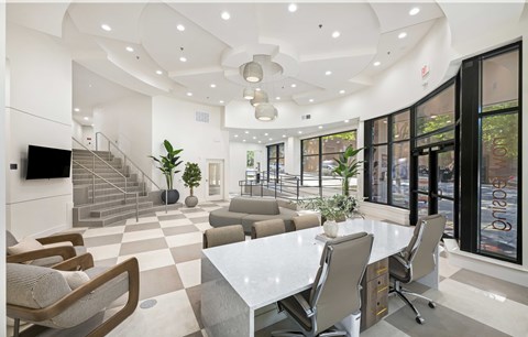 A modern living room with a white dining table and chairs.