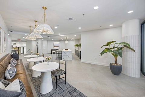A modern living room with a brown couch and a white table.