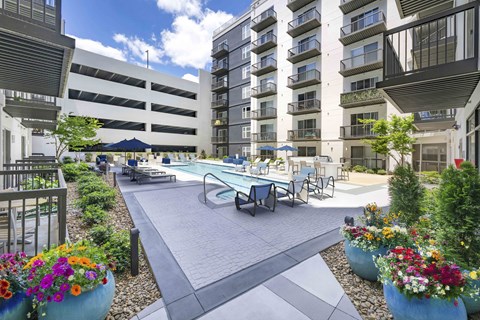 A courtyard with a pool and apartment buildings.