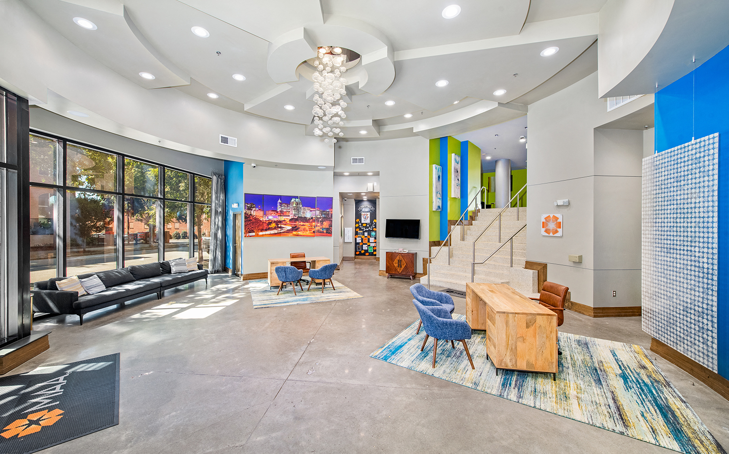 a living room with blue and white walls and a spiral staircase