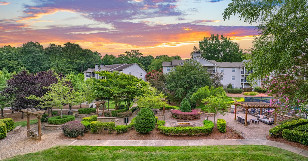 an aerial view of a garden with trees and buildings
