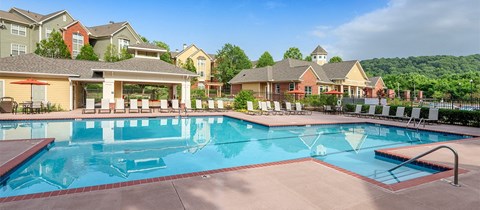 a swimming pool with apartments in the background