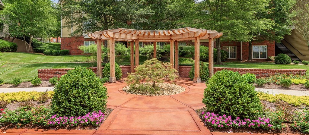 a garden with a wooden gazebo