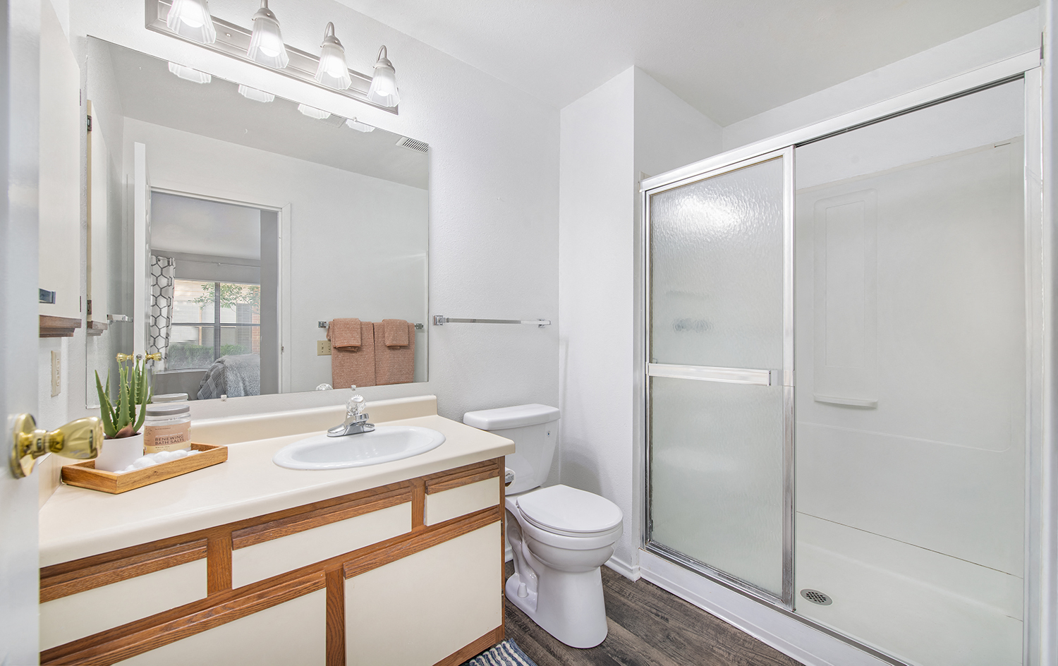 a white bathroom with a shower toilet and sink