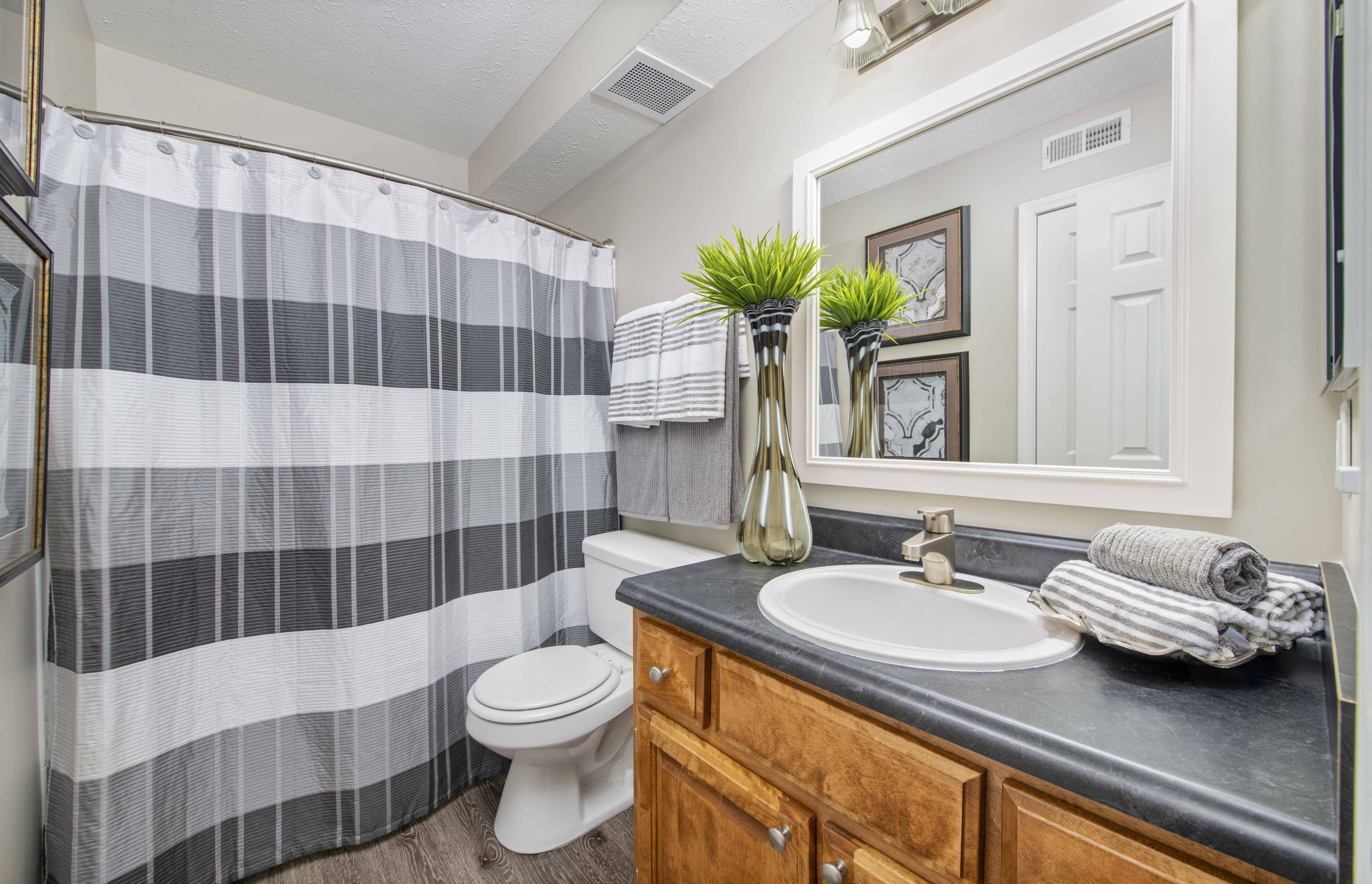 a bathroom with a shower and a sink and a toilet