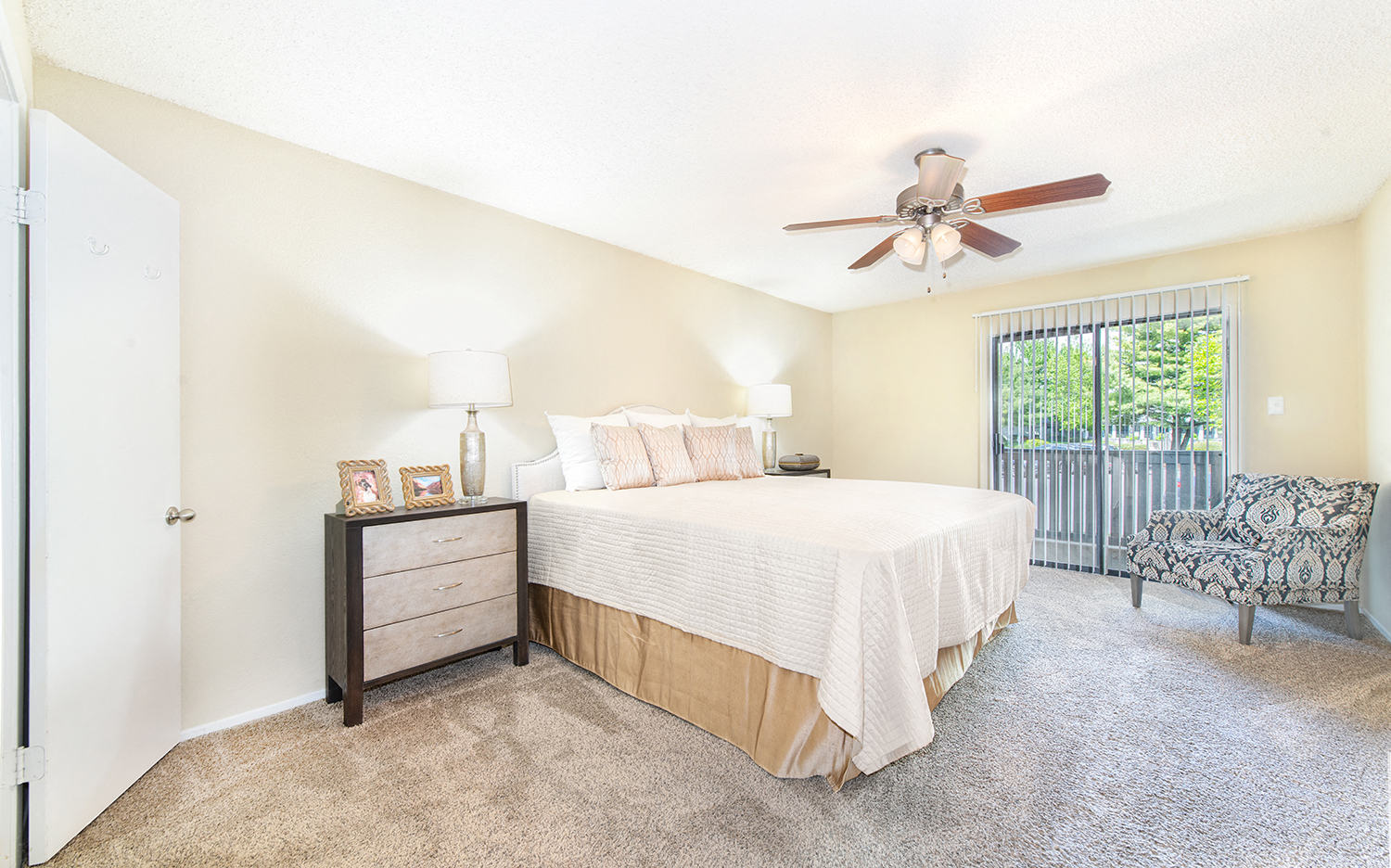 a bedroom with a bed and a ceiling fan