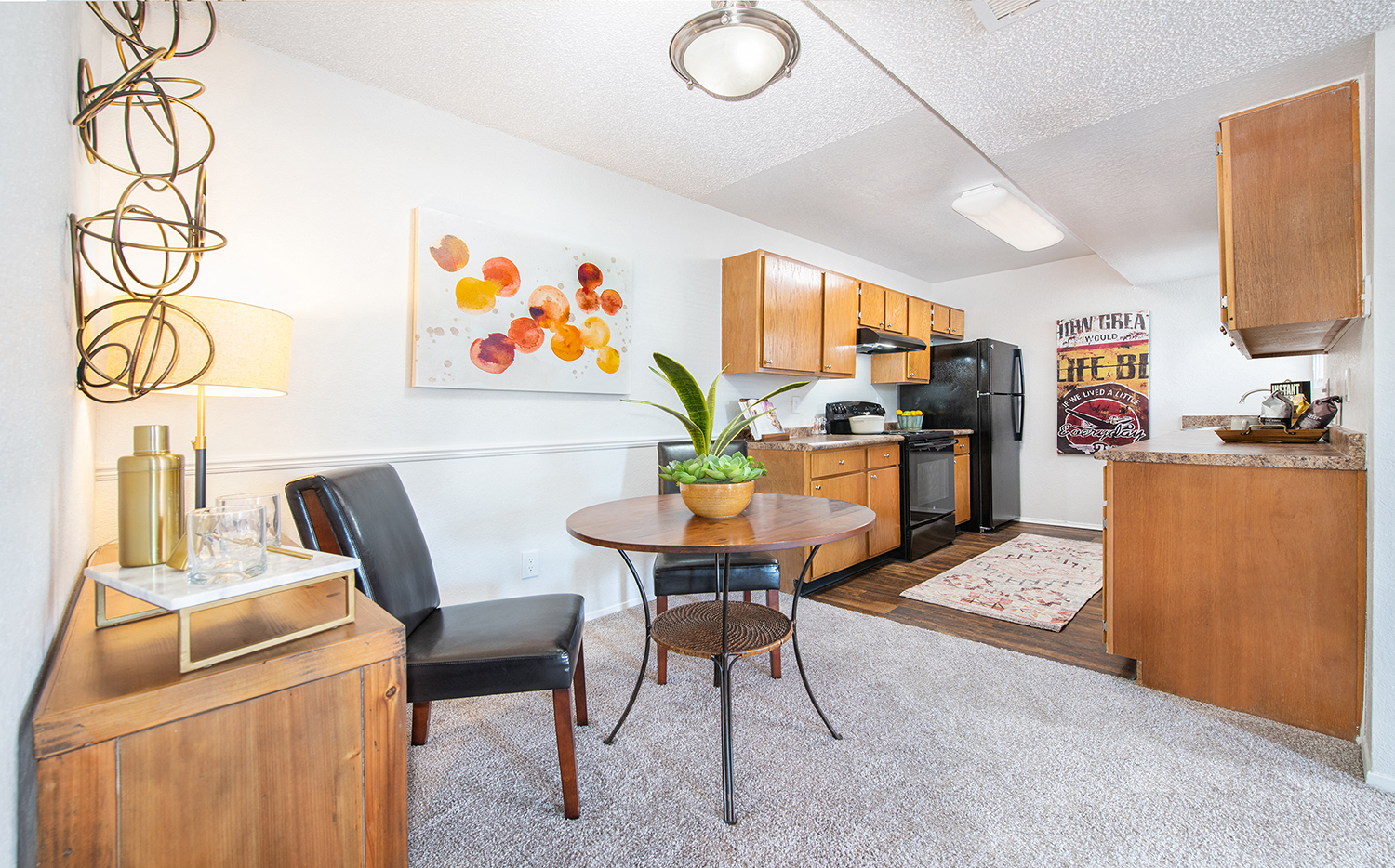 a living room with a dining room table and a kitchen