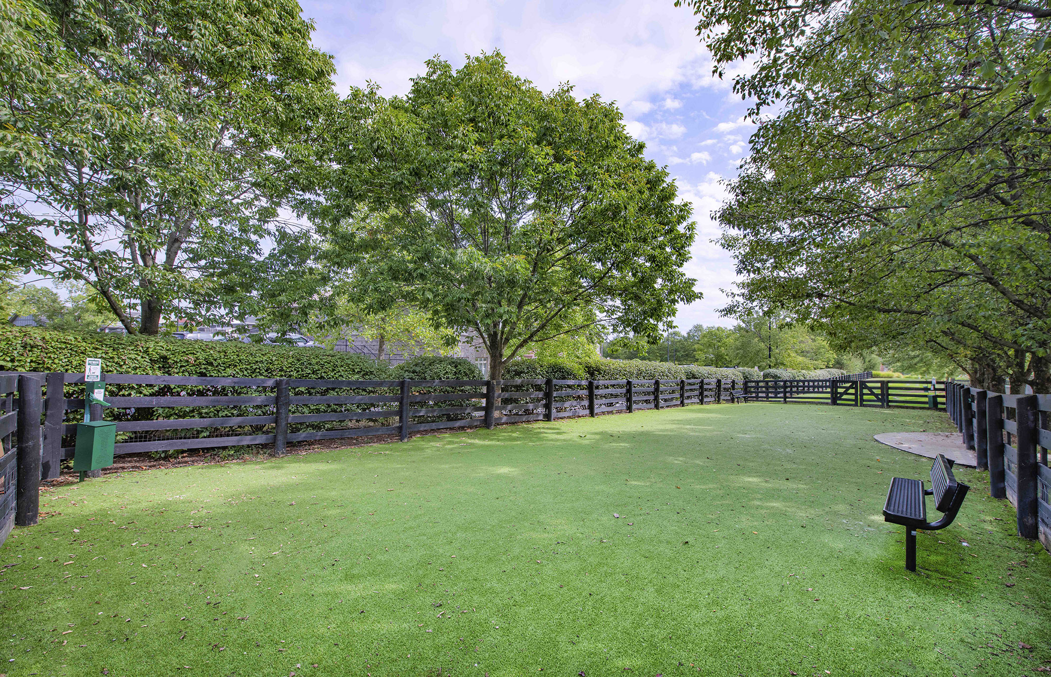 a park bench sitting on top of a lush green field