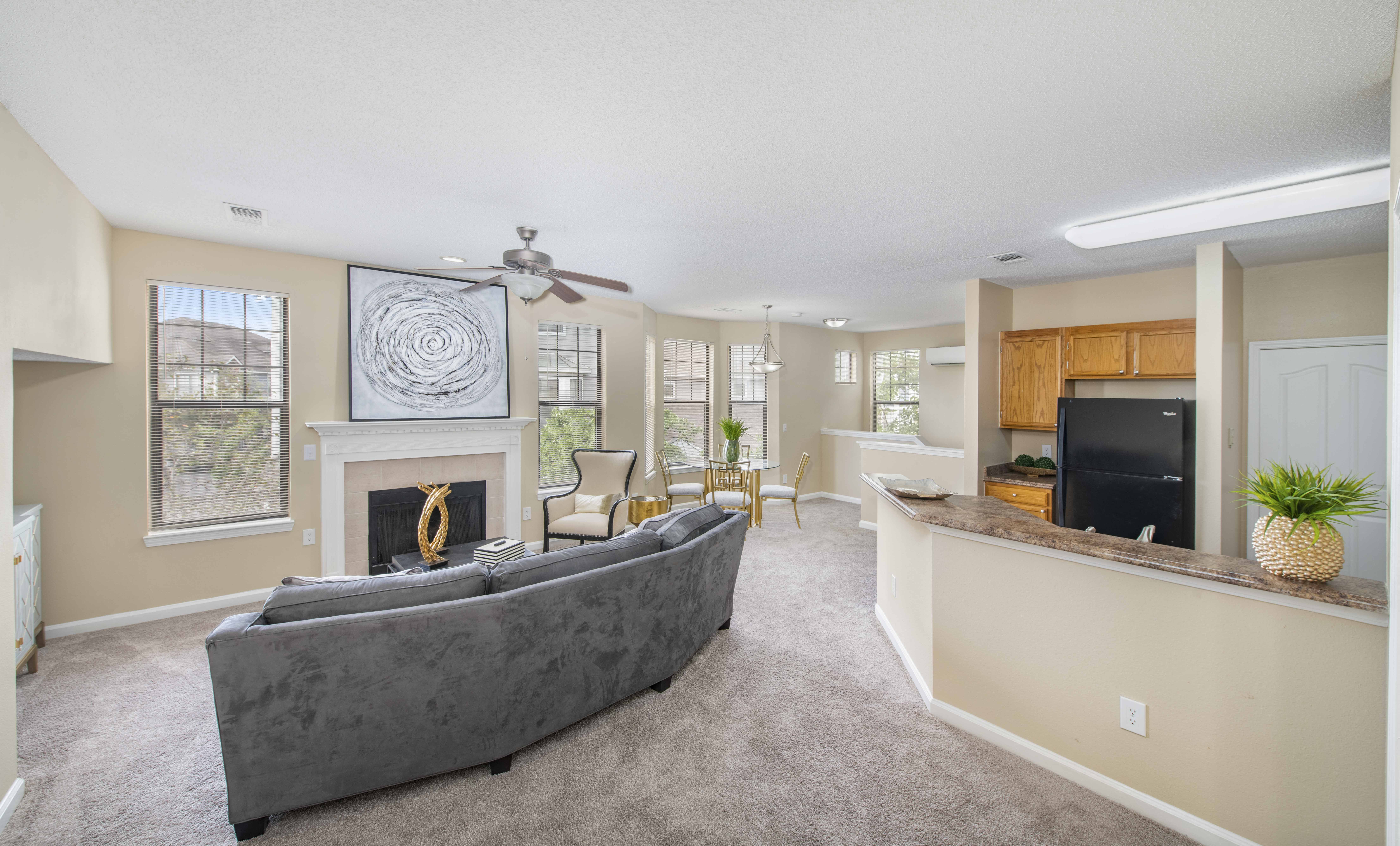 a living room with a couch in front of a fireplace