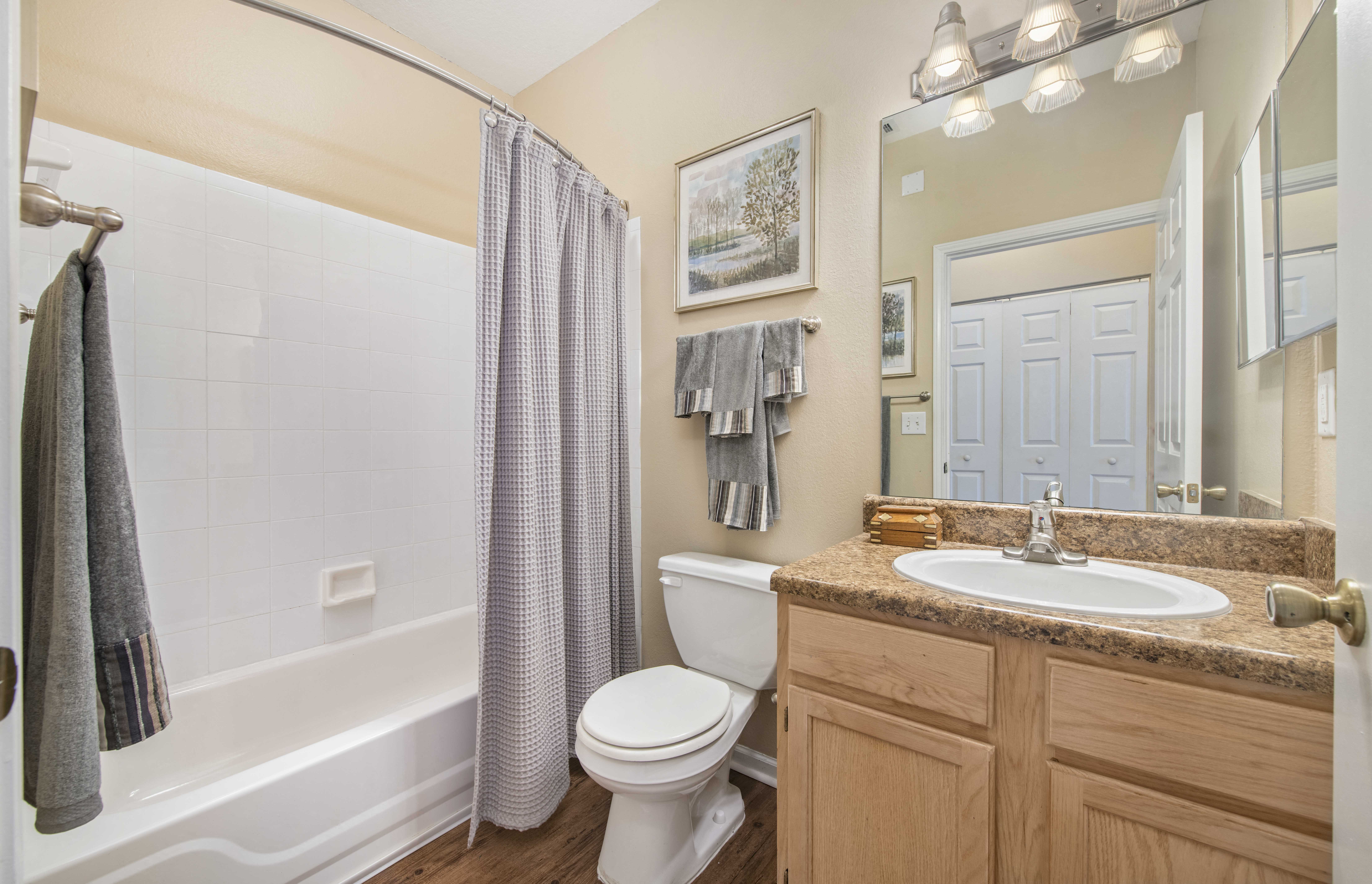 a bathroom with a sink toilet and shower