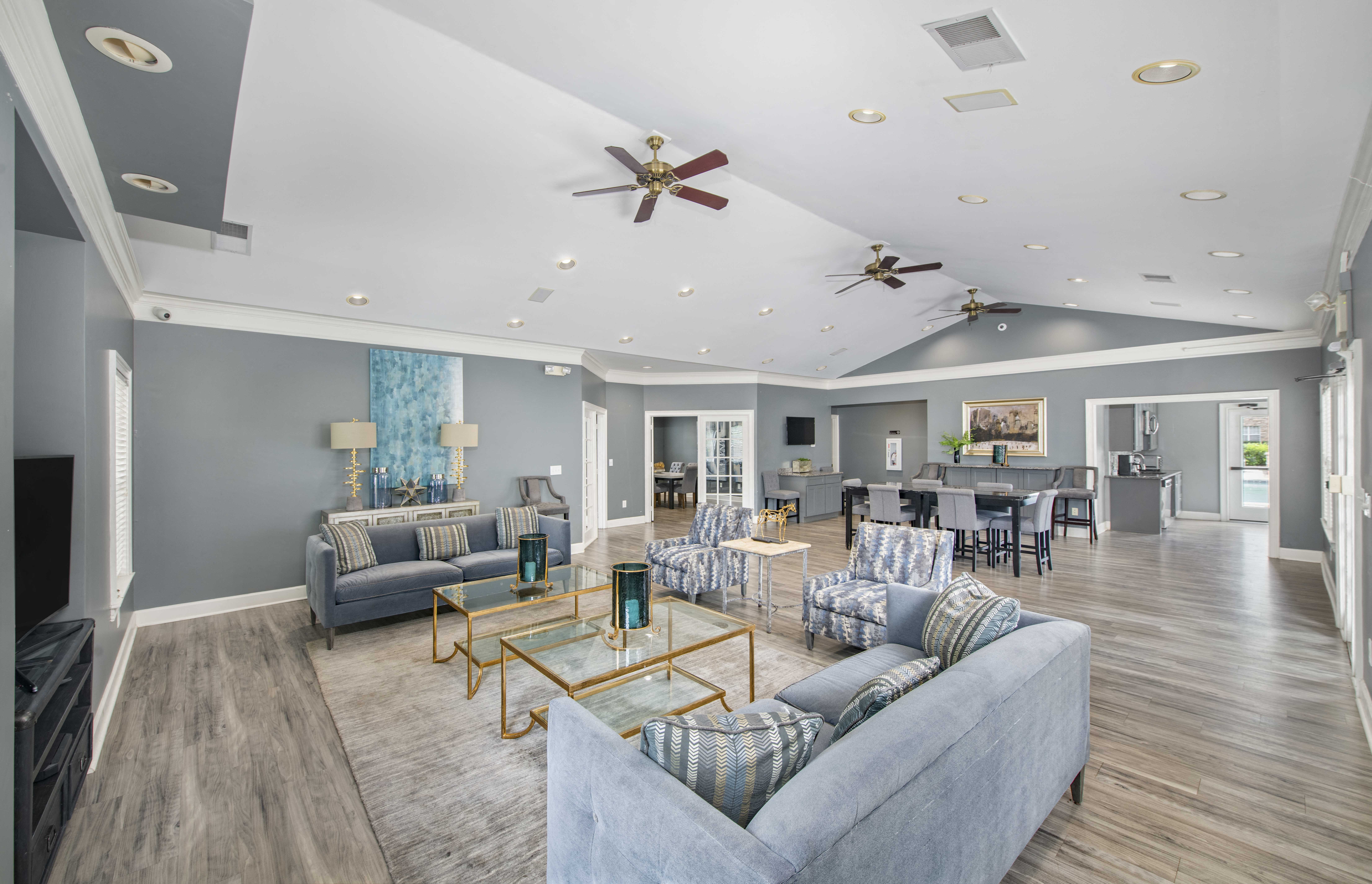 a living room with couches and chairs and a dining room