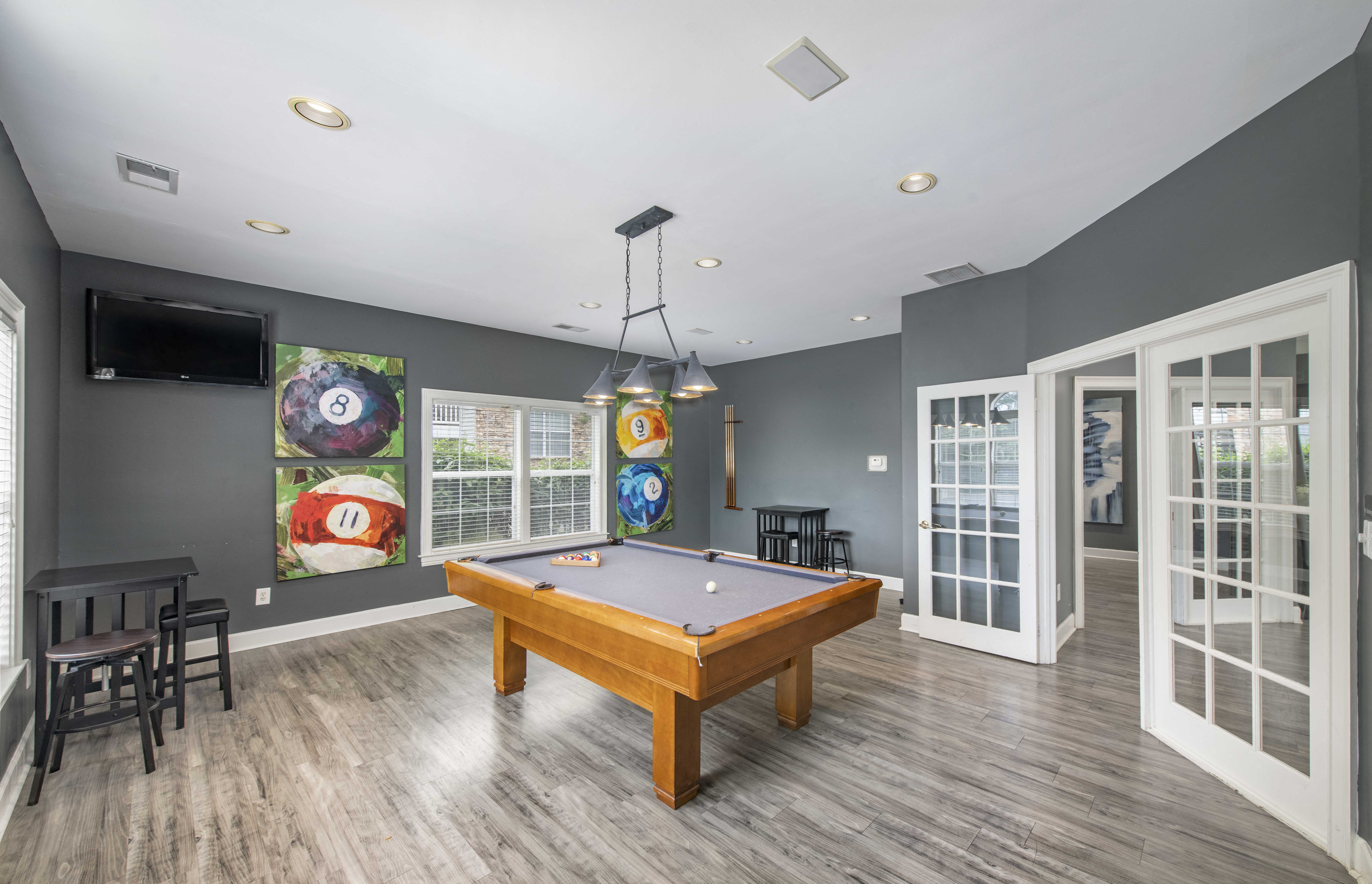 a game room with a pool table and a tv