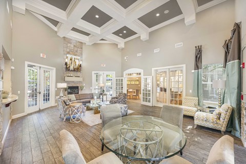 a living room with couches and chairs and a glass table