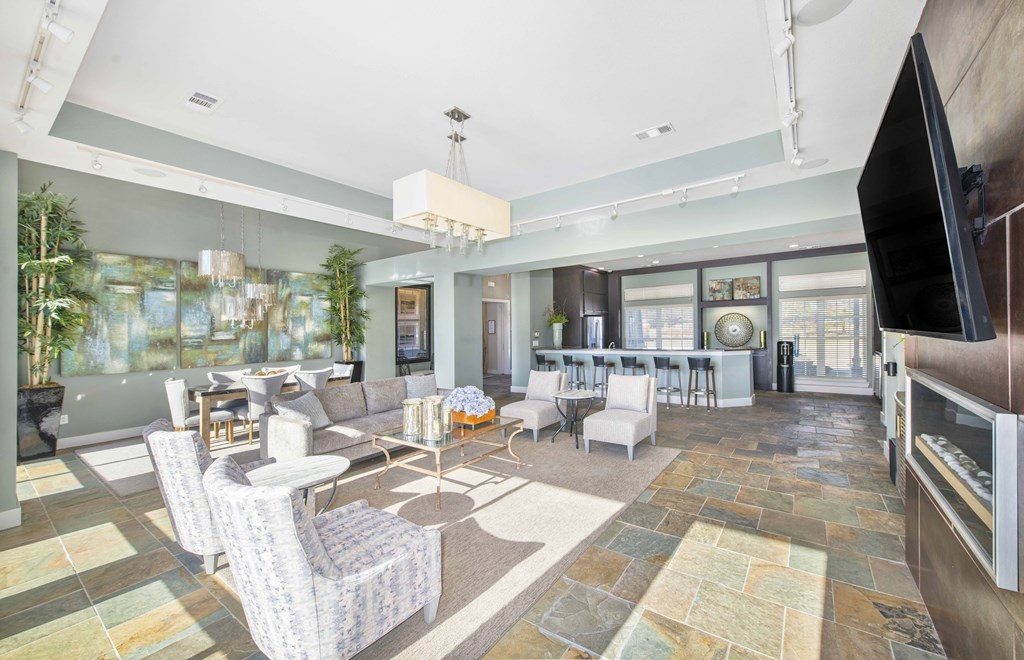 a living room with couches and chairs and a television