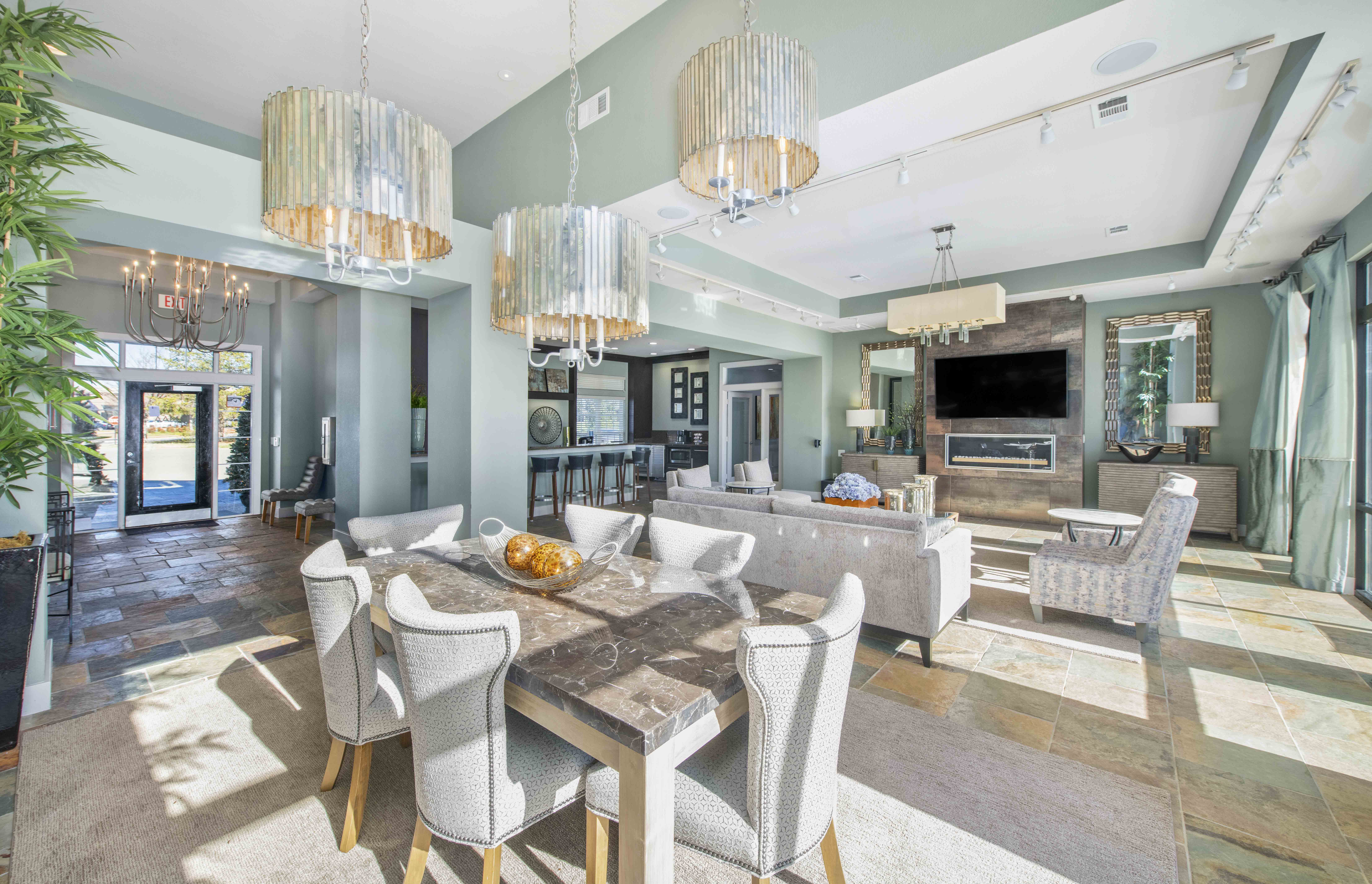 a dining room and living room with chandeliers