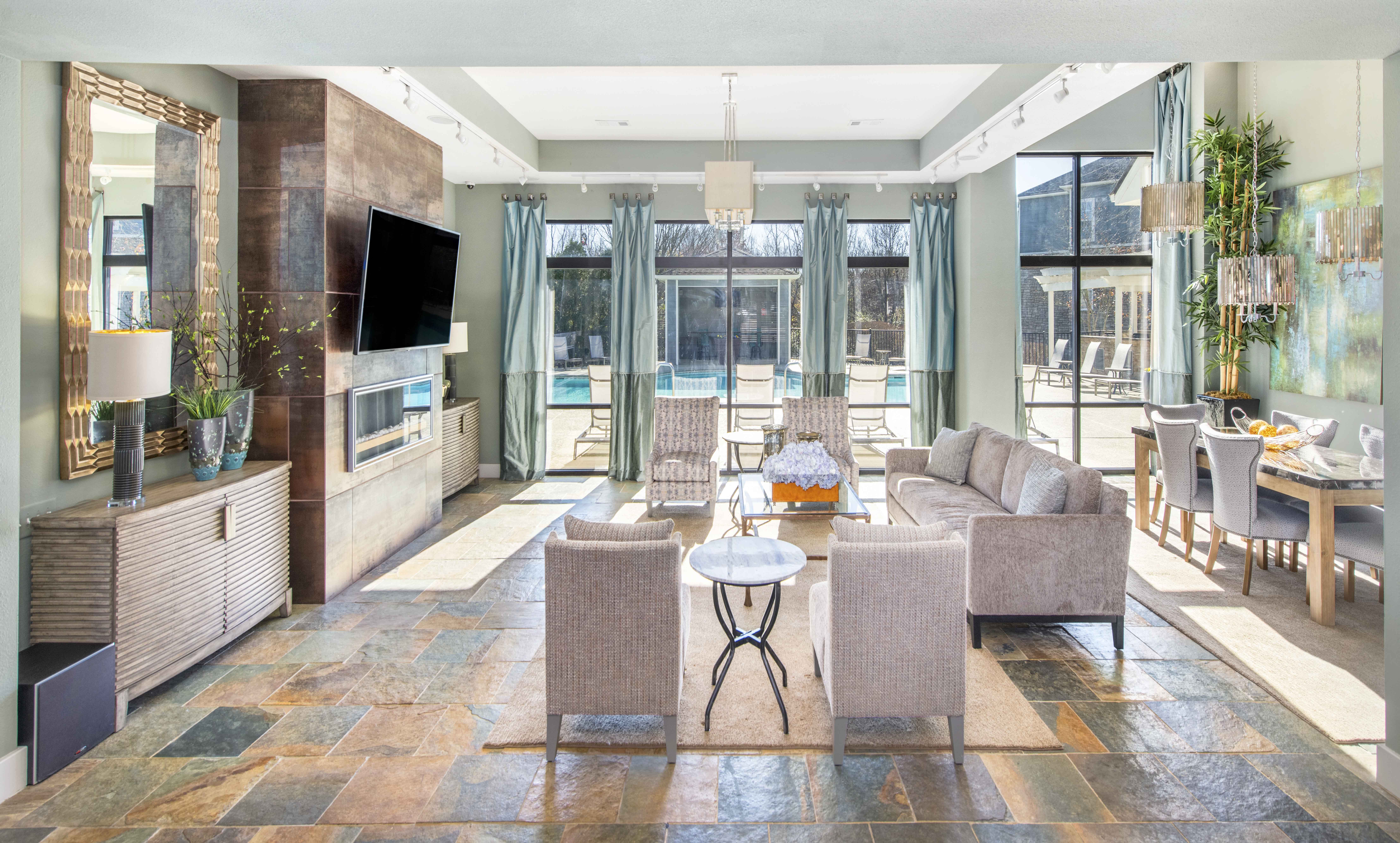 a living room with a couch and chairs and a television
