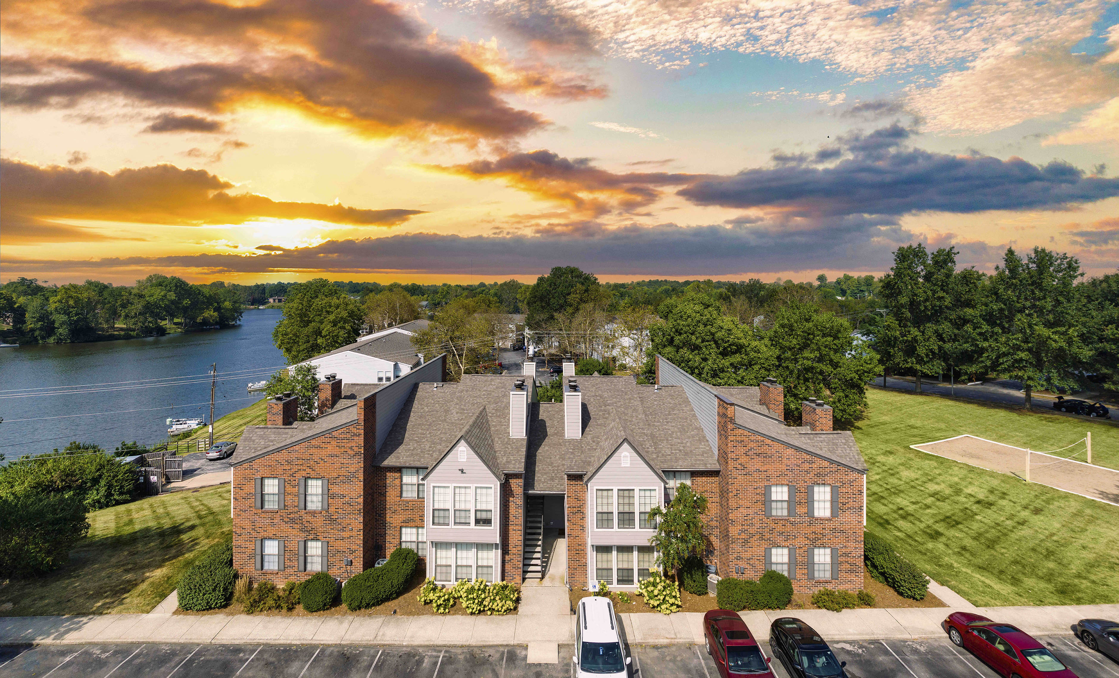 an aerial view of a house with a river in the background