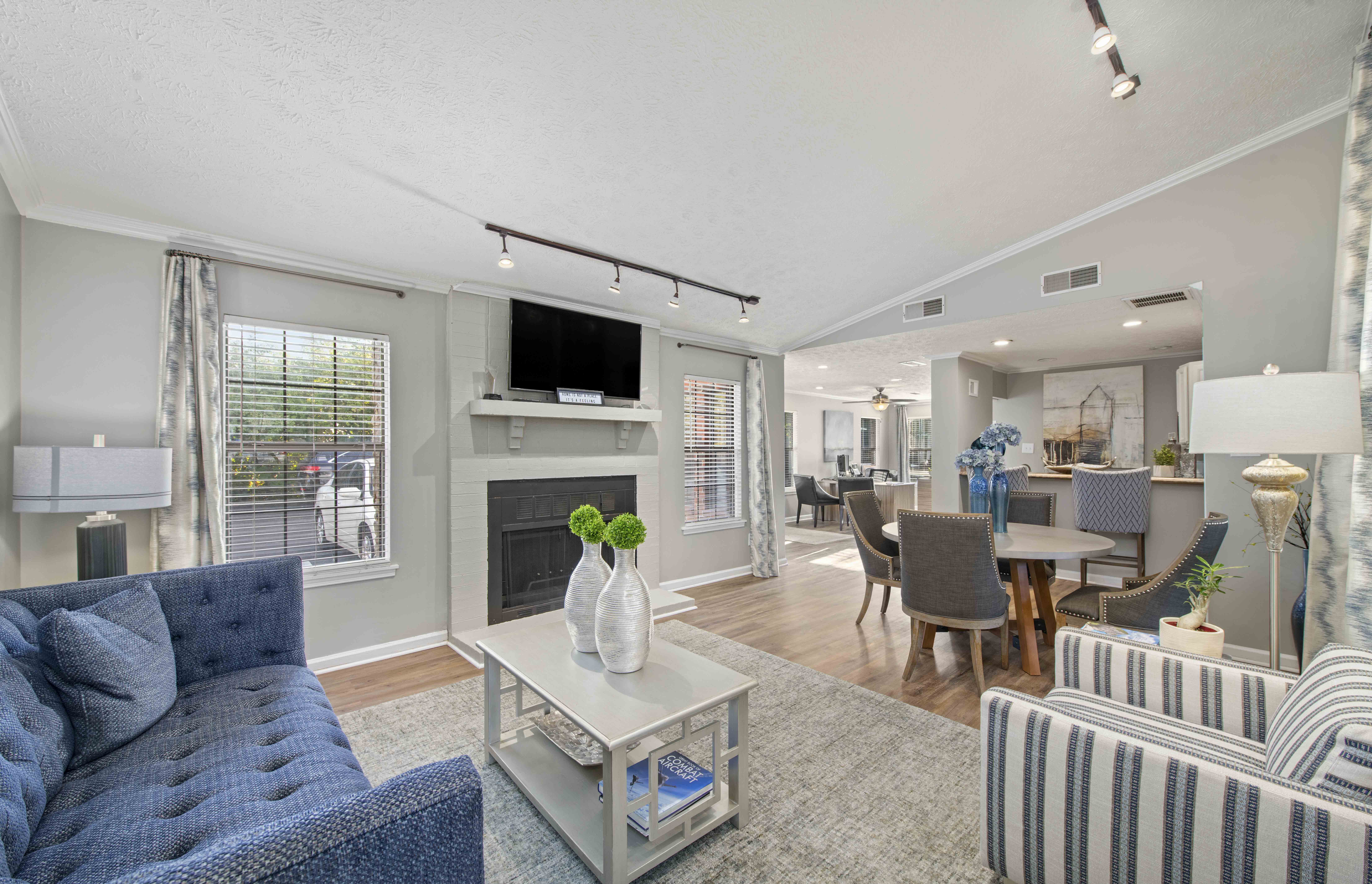 a living room with a fireplace and a table with chairs