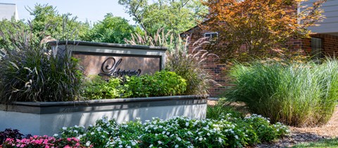 a retaining wall with a sign in a garden