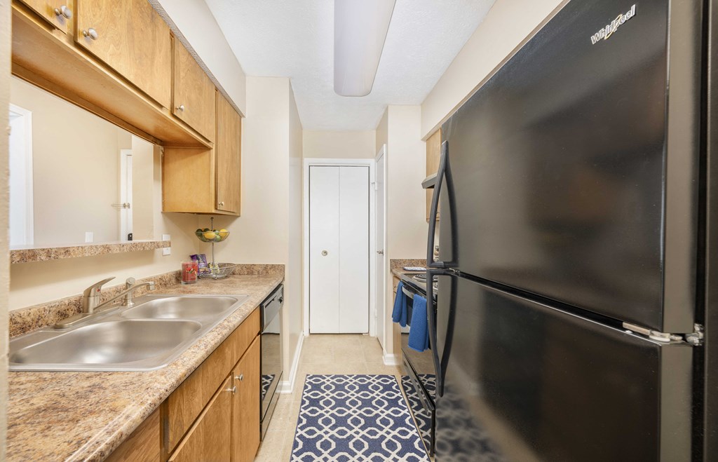 a kitchen with a stainless steel refrigerator and a sink