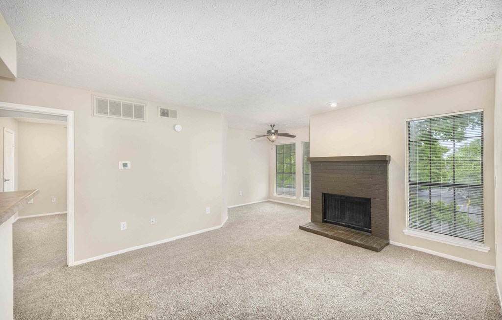 a living room with a fireplace and a window