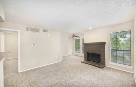 a living room with a fireplace and a window