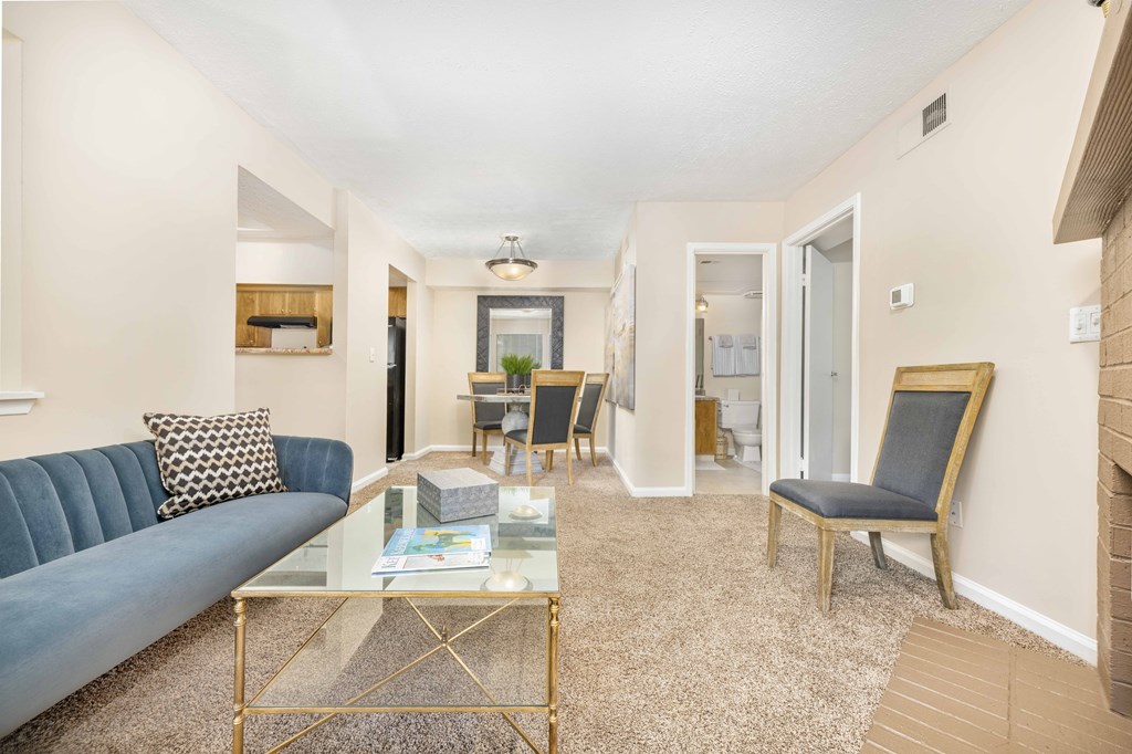 a living room with a couch and a glass coffee table