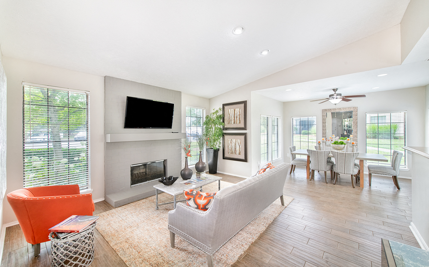 a living room with a fireplace and a table with chairs