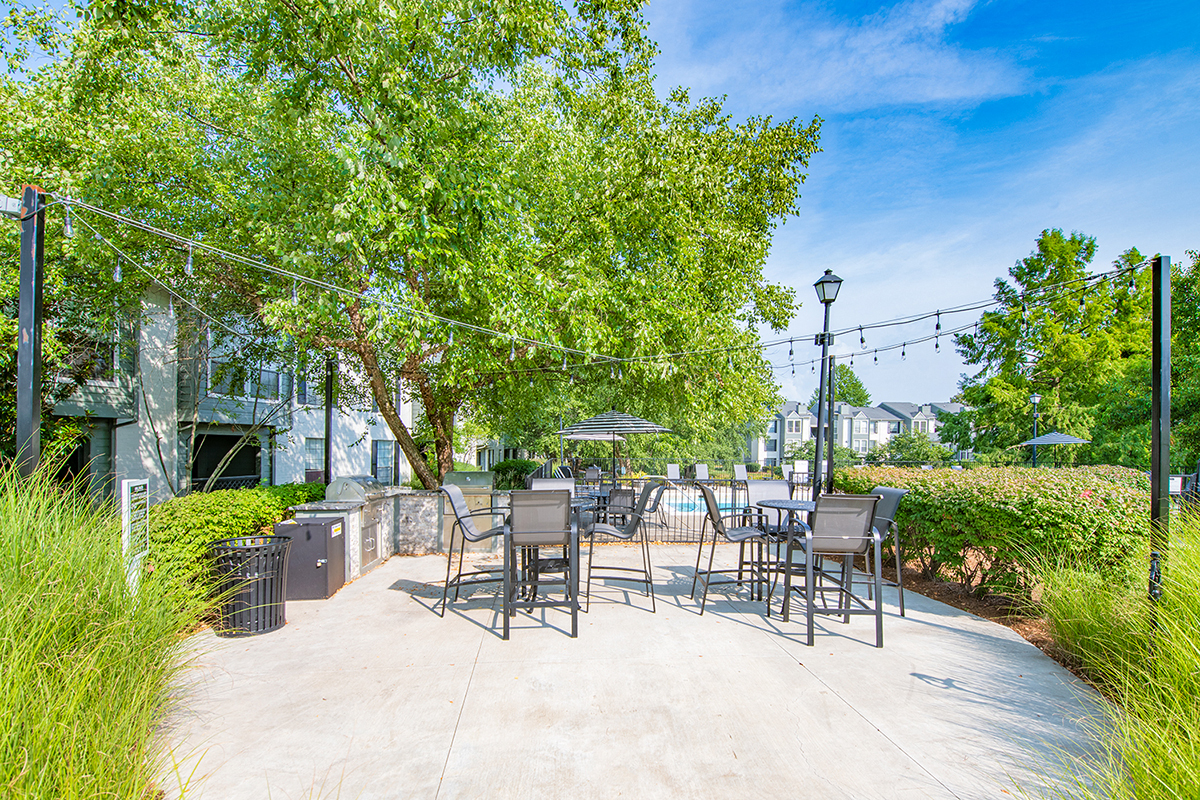 the preserve at ballantyne commons commons patio with tables and chairs and trees