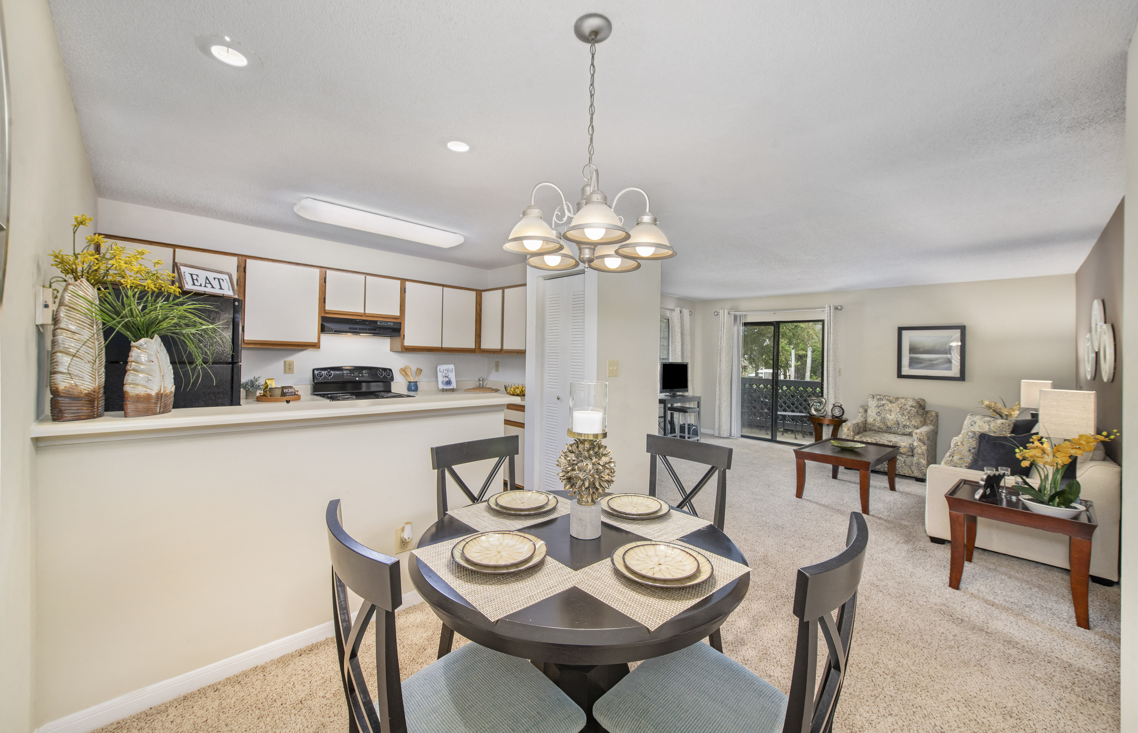 a dining room with a table and chairs and a kitchen