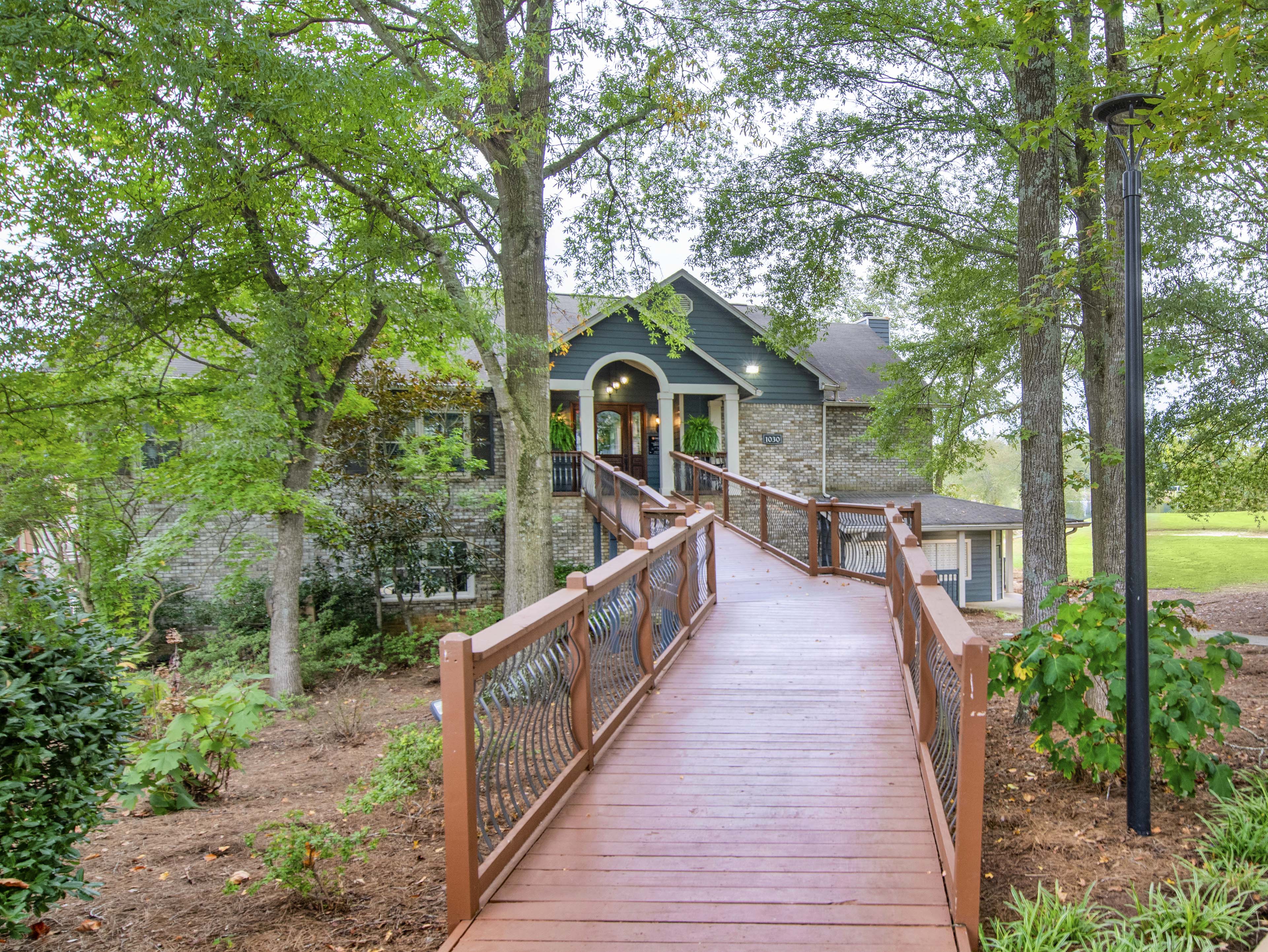a house with a wooden bridge leading to it