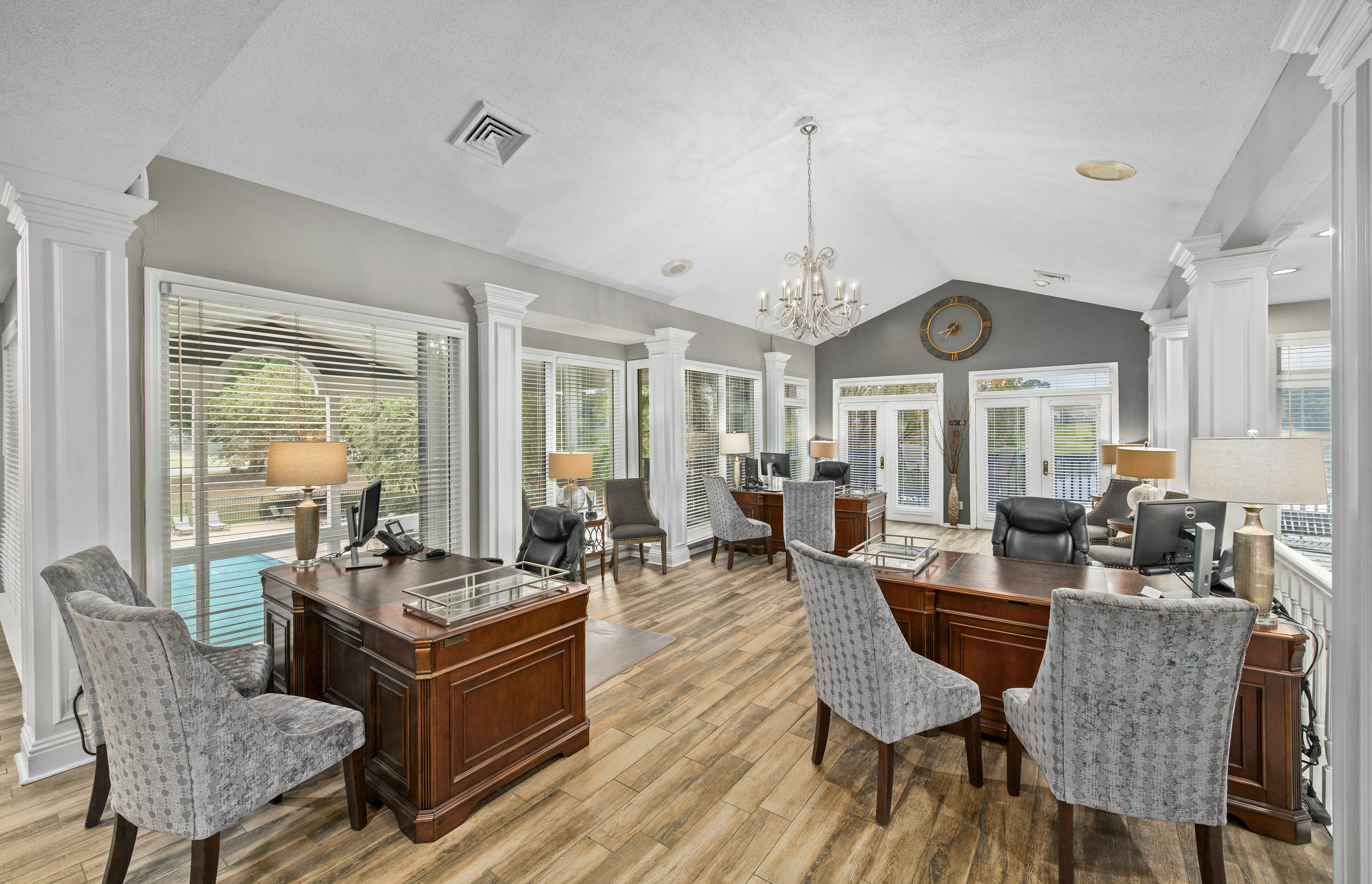 a dining room with a table and chairs and a living room with windows
