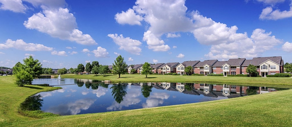 a pond in front of a row of houses