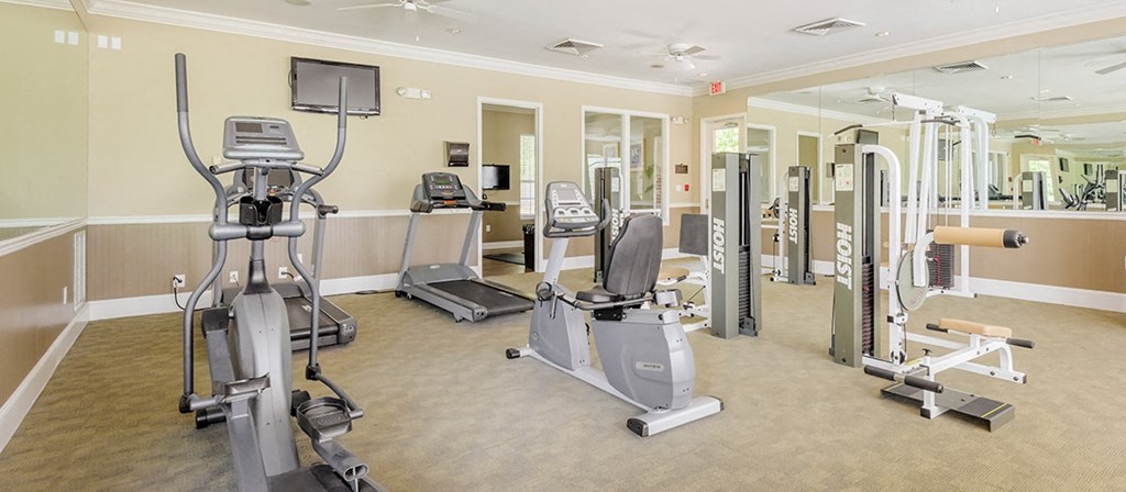 a gym with cardio machines and other exercise equipment