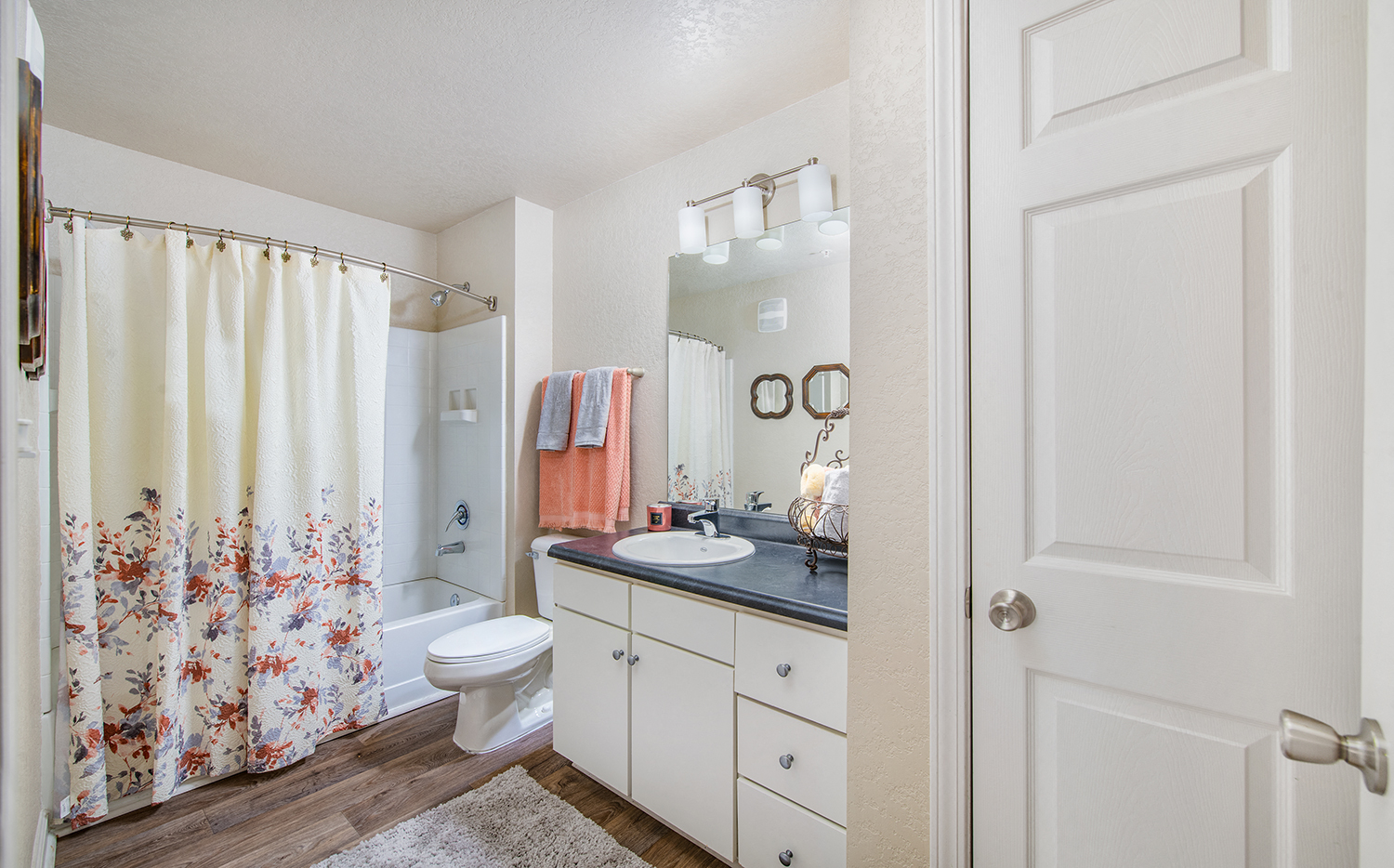a bathroom with a shower and a sink and a toilet