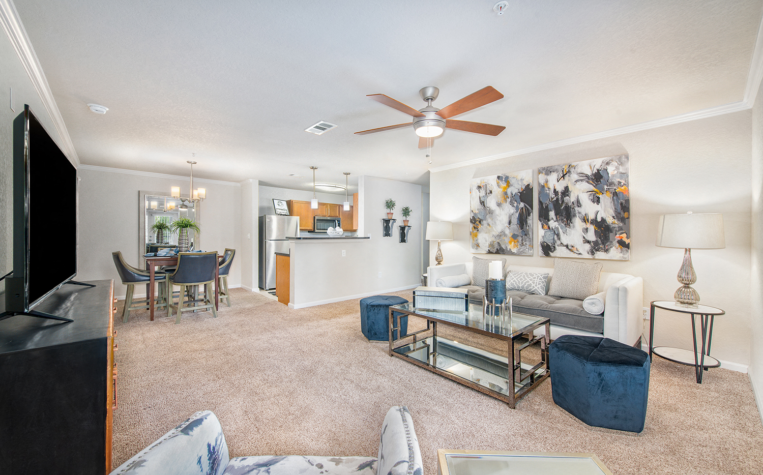 a living room with a couch and a ceiling fan
