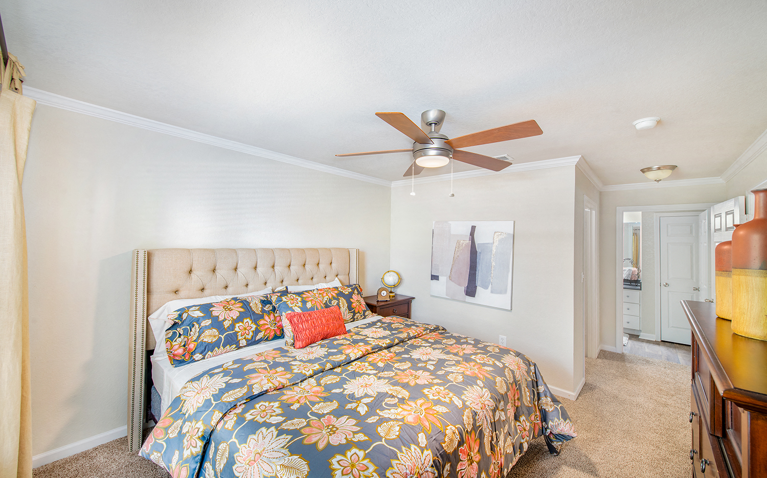 a bedroom with a bed and a ceiling fan