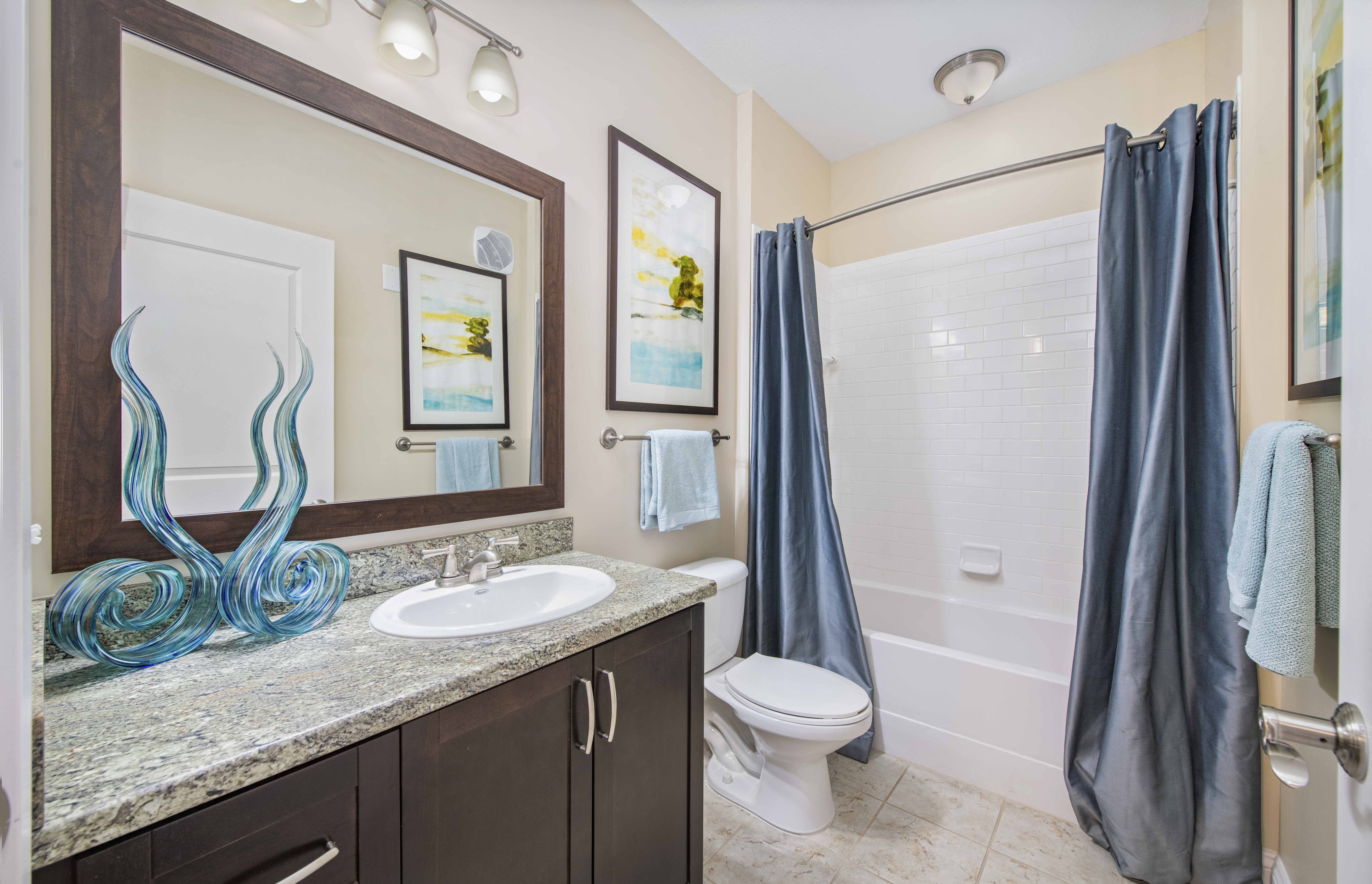 a bathroom with a sink and a toilet and a shower