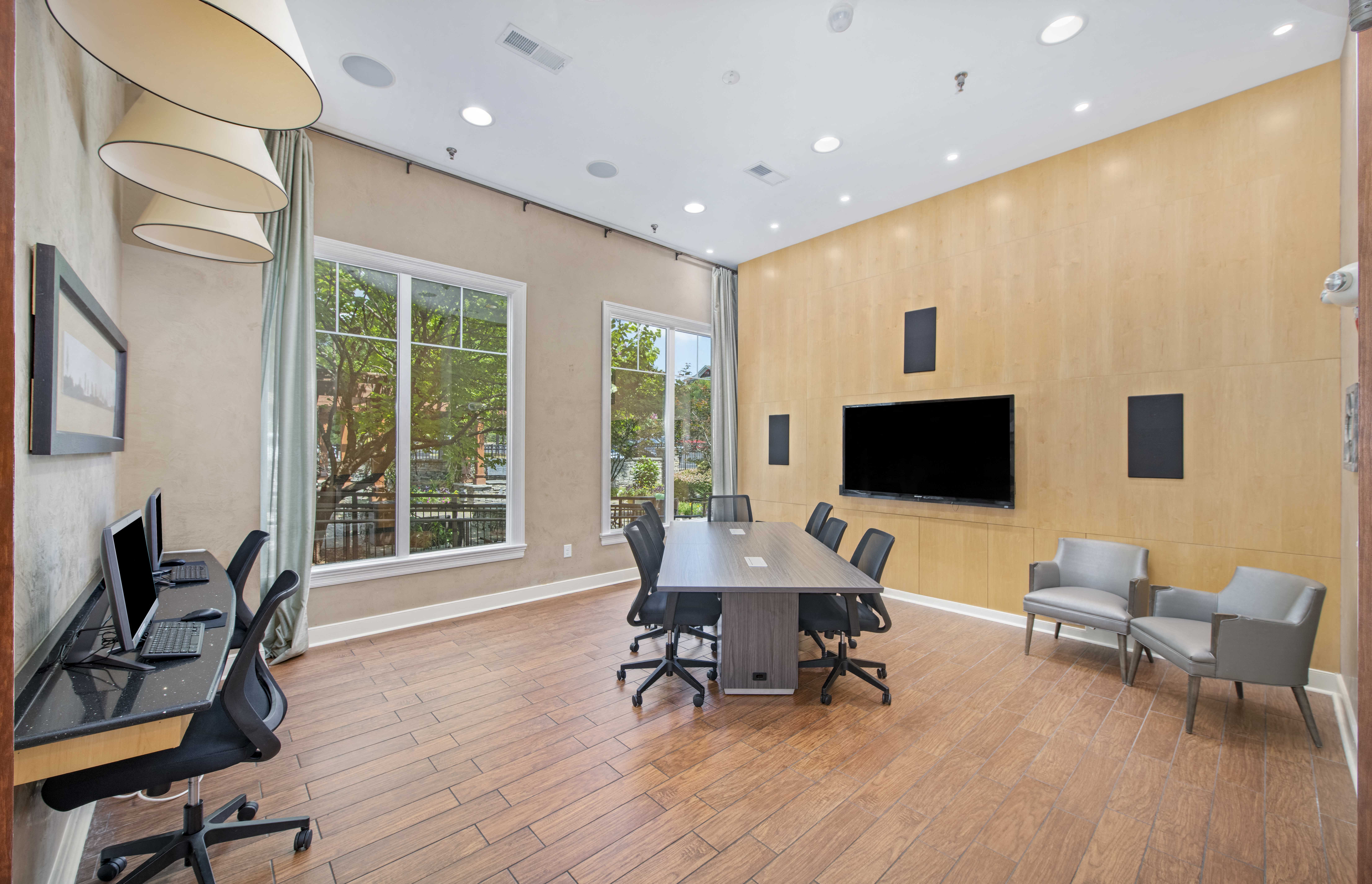 a conference room with a table and chairs and a large window