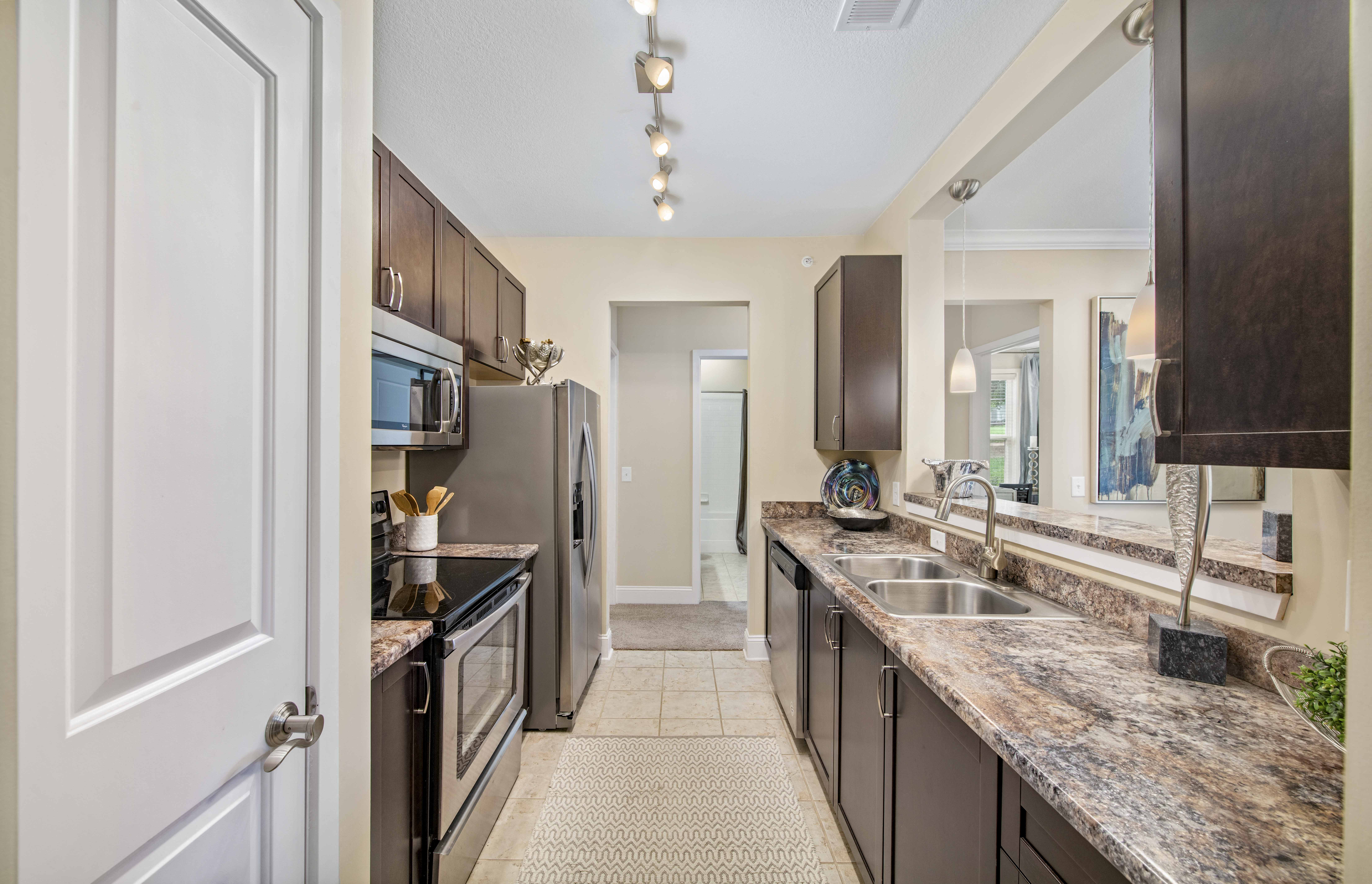 a kitchen with stainless steel appliances and granite counter tops
