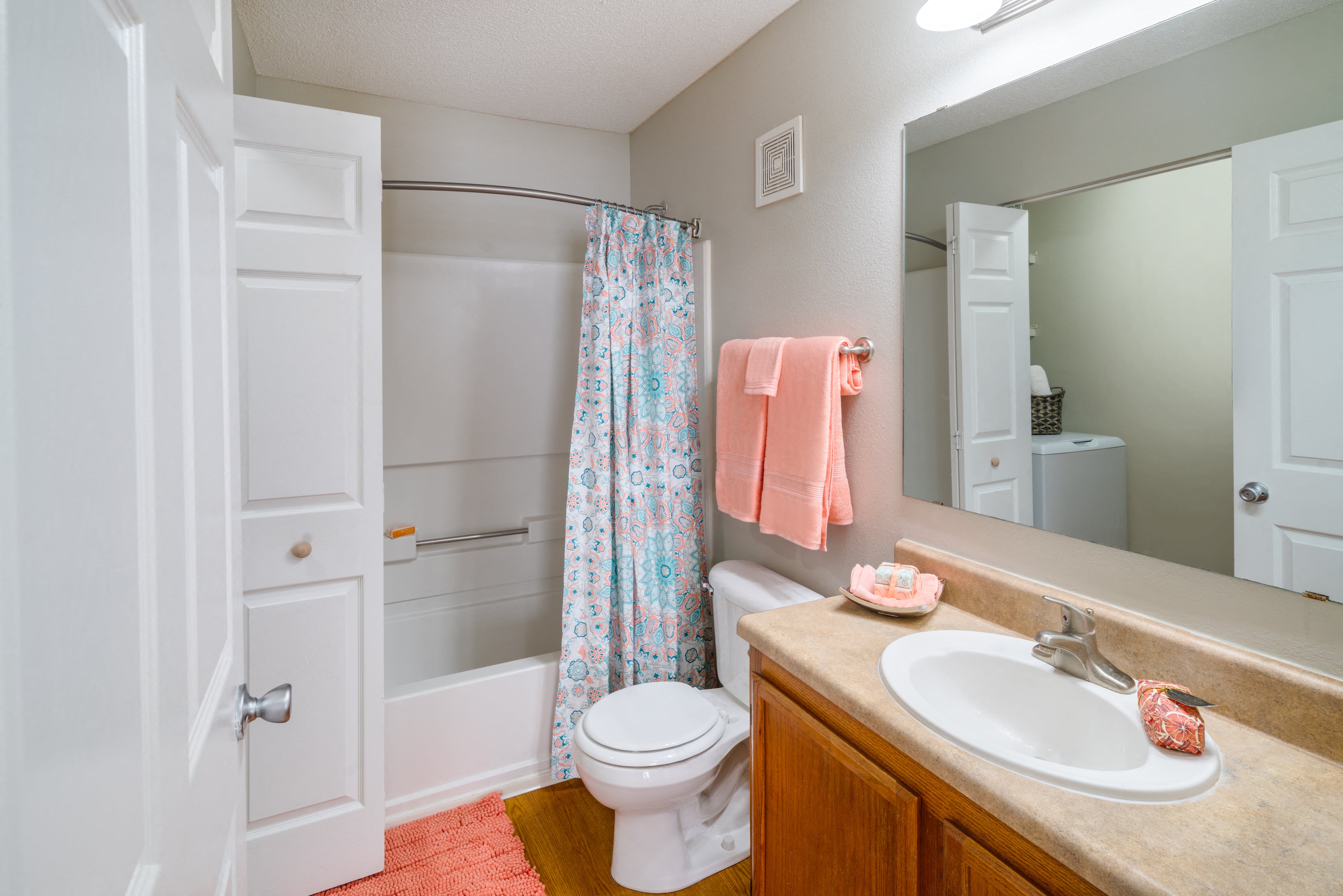 a bathroom with a shower toilet and sink and a mirror