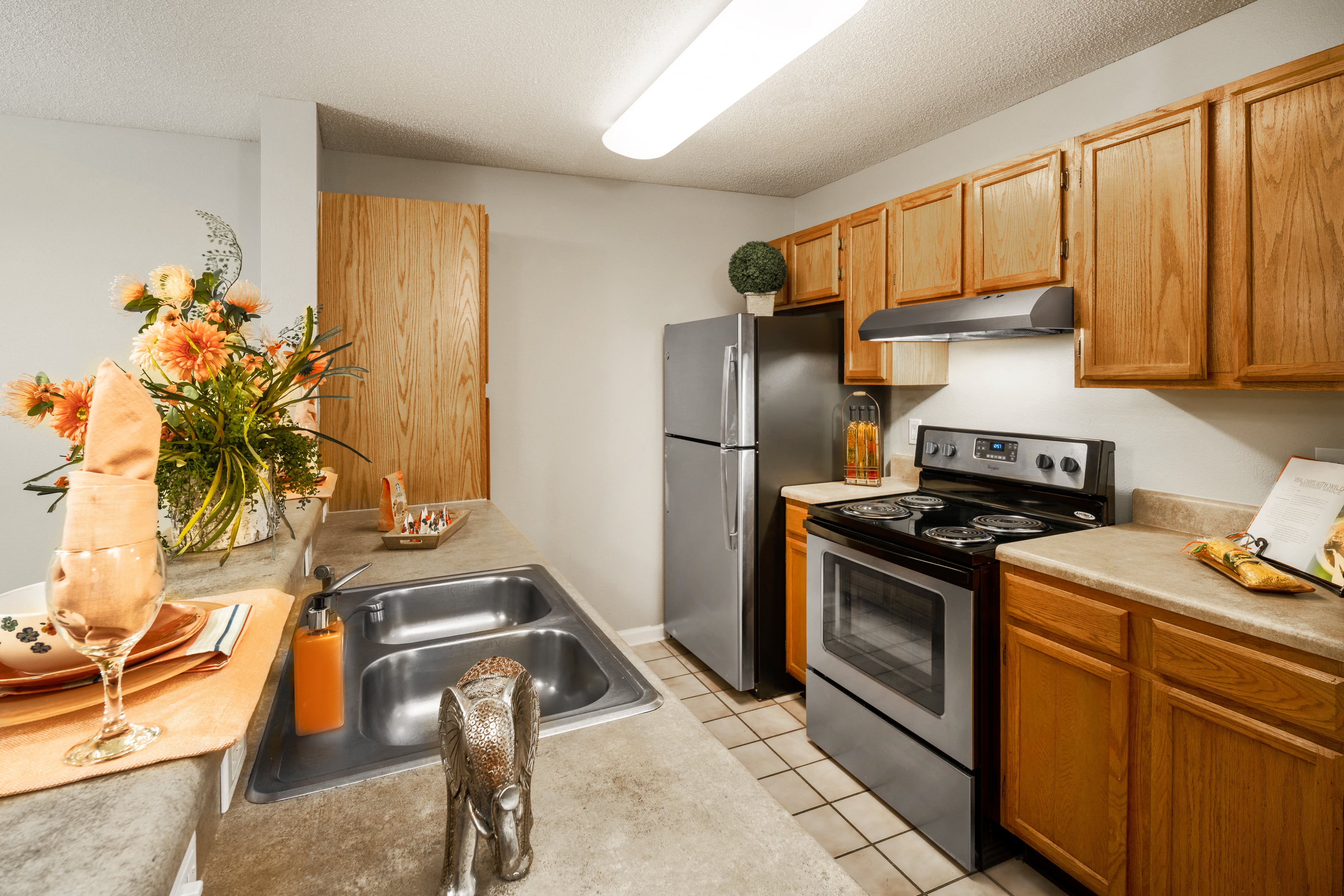 a kitchen with stainless steel appliances and wooden cabinets