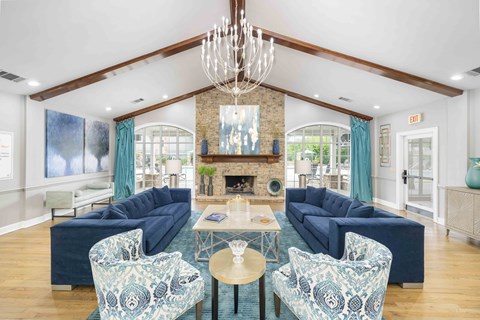 A living room with a fireplace and a chandelier.