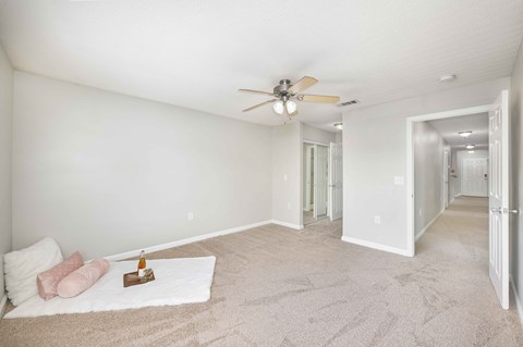 A bedroom with a bed and a fan.