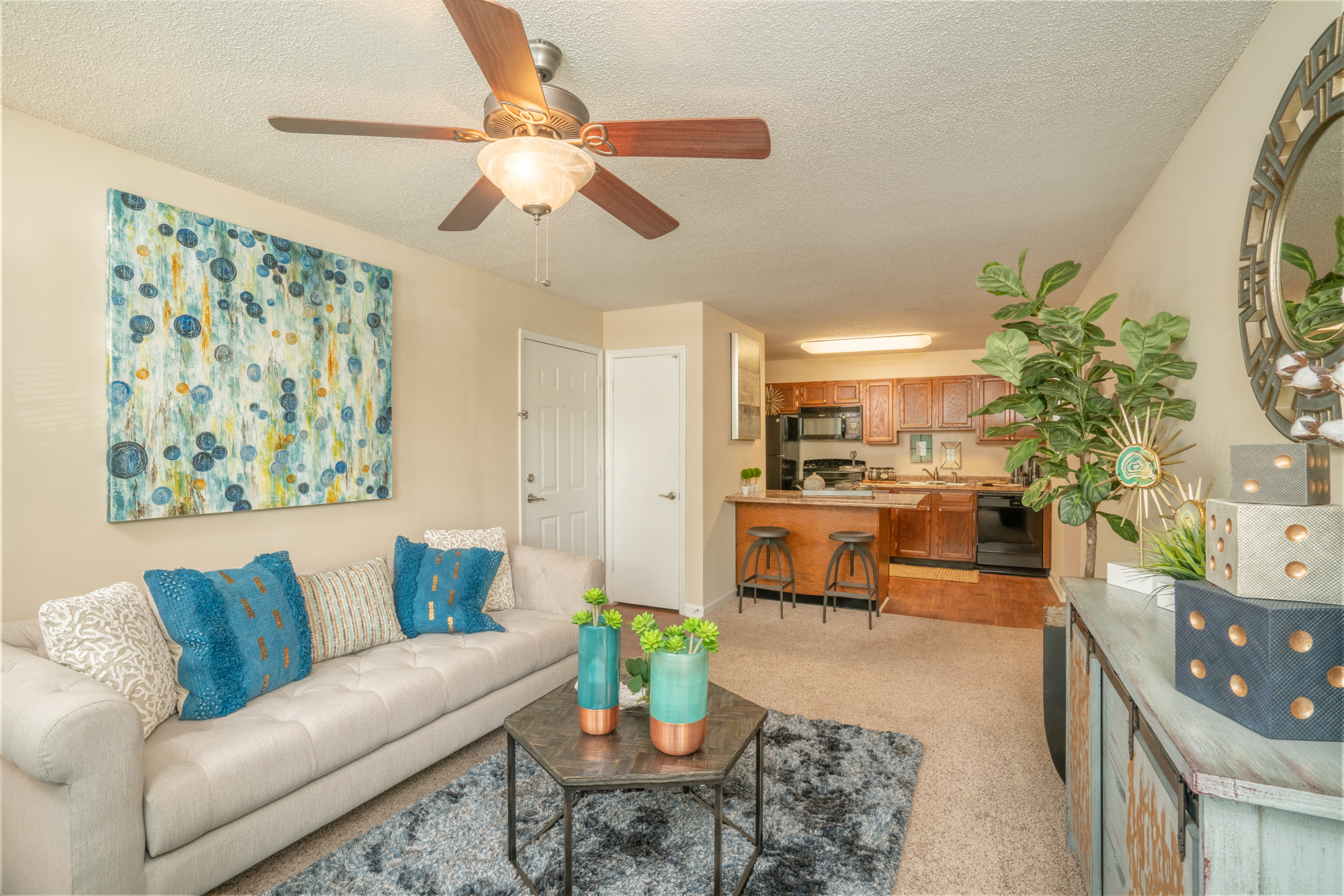 a living room with a couch and a ceiling fan