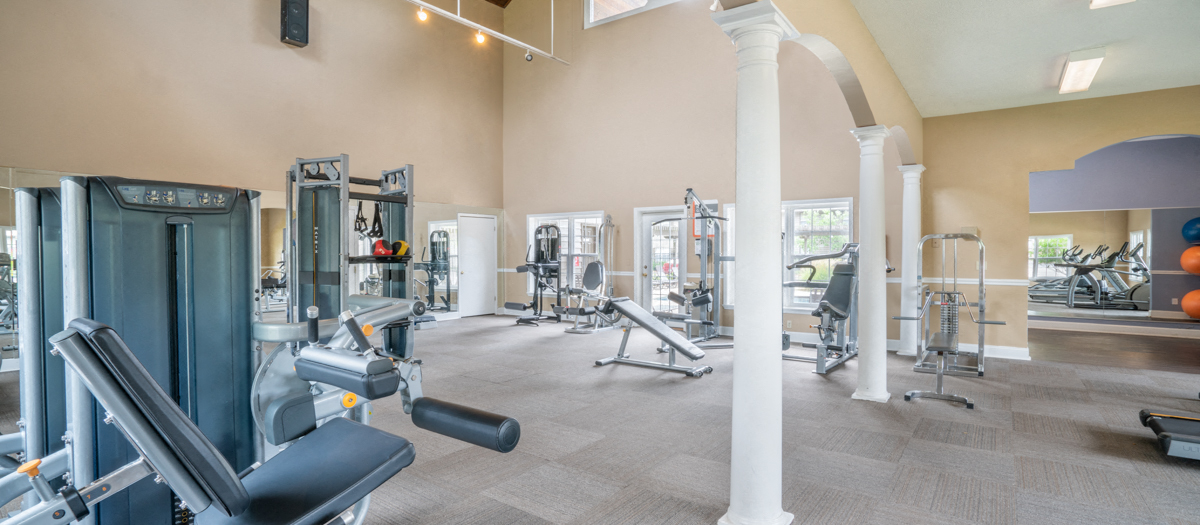 a gym with weights and cardio equipment at the community center