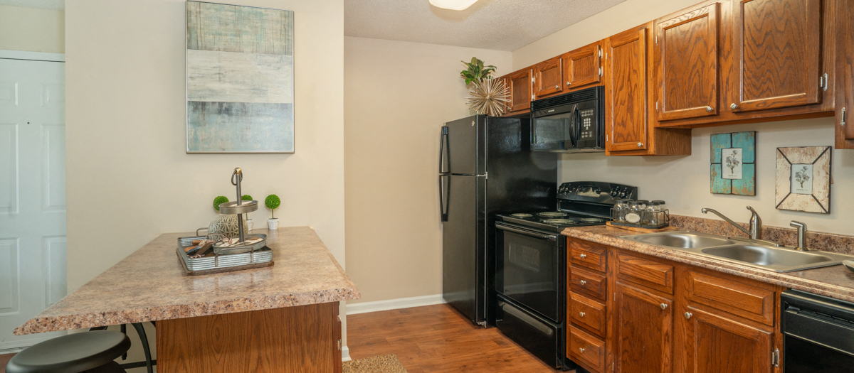 a kitchen with black appliances and a granite counter top