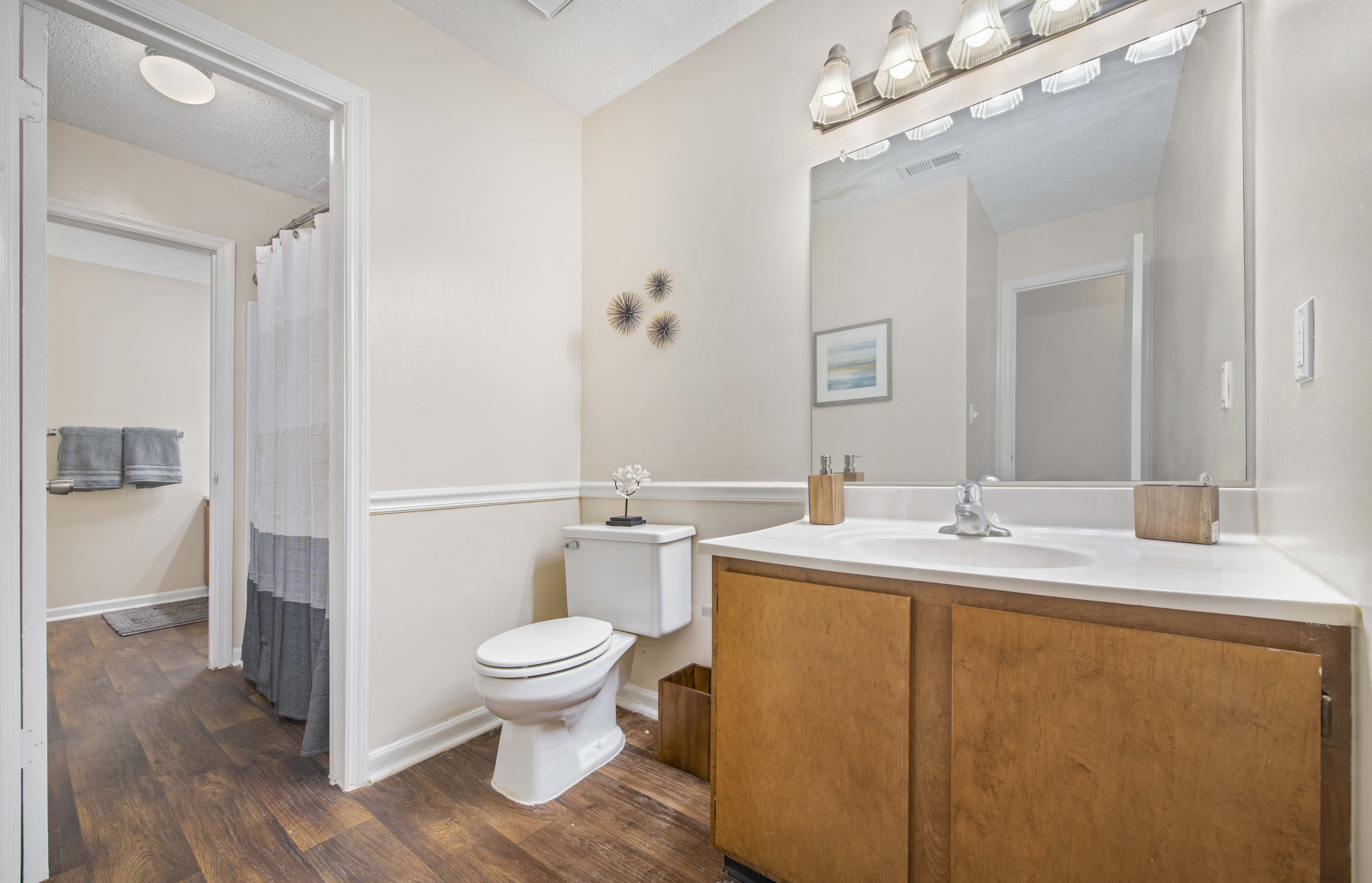a bathroom with a toilet and a sink and a mirror