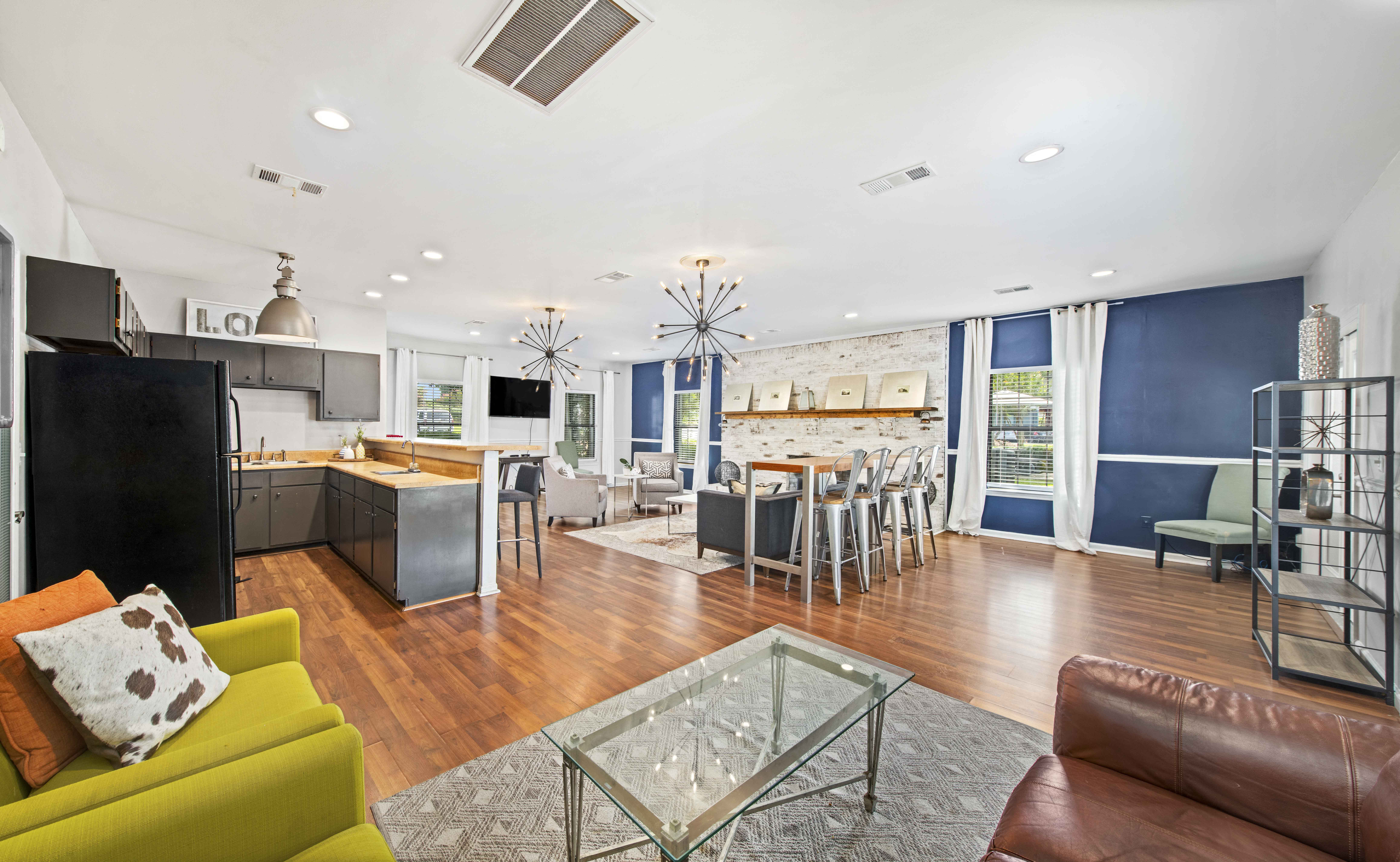 a living room with a kitchen and a couch and a table