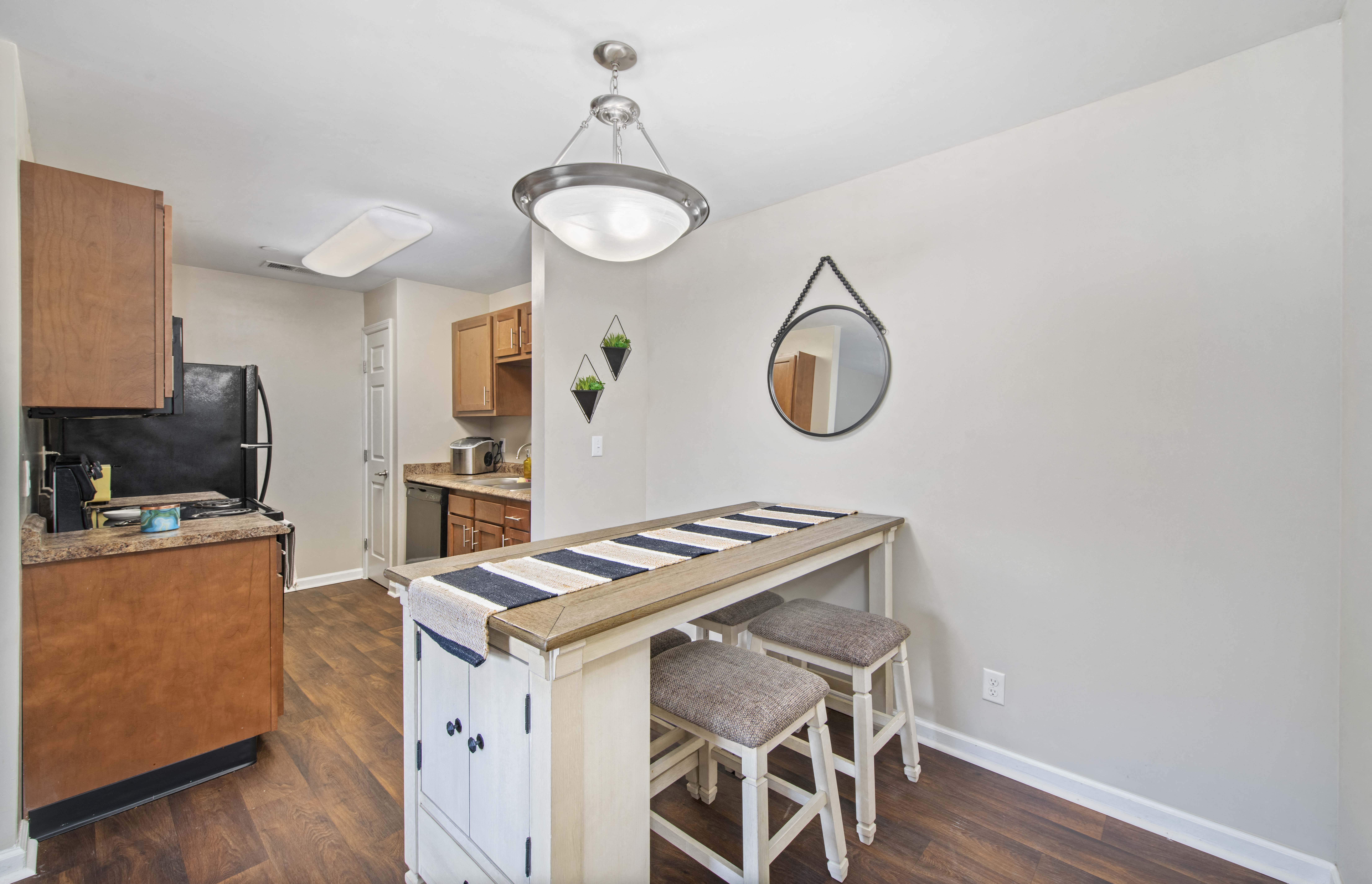 a kitchen with a bar with three stools
